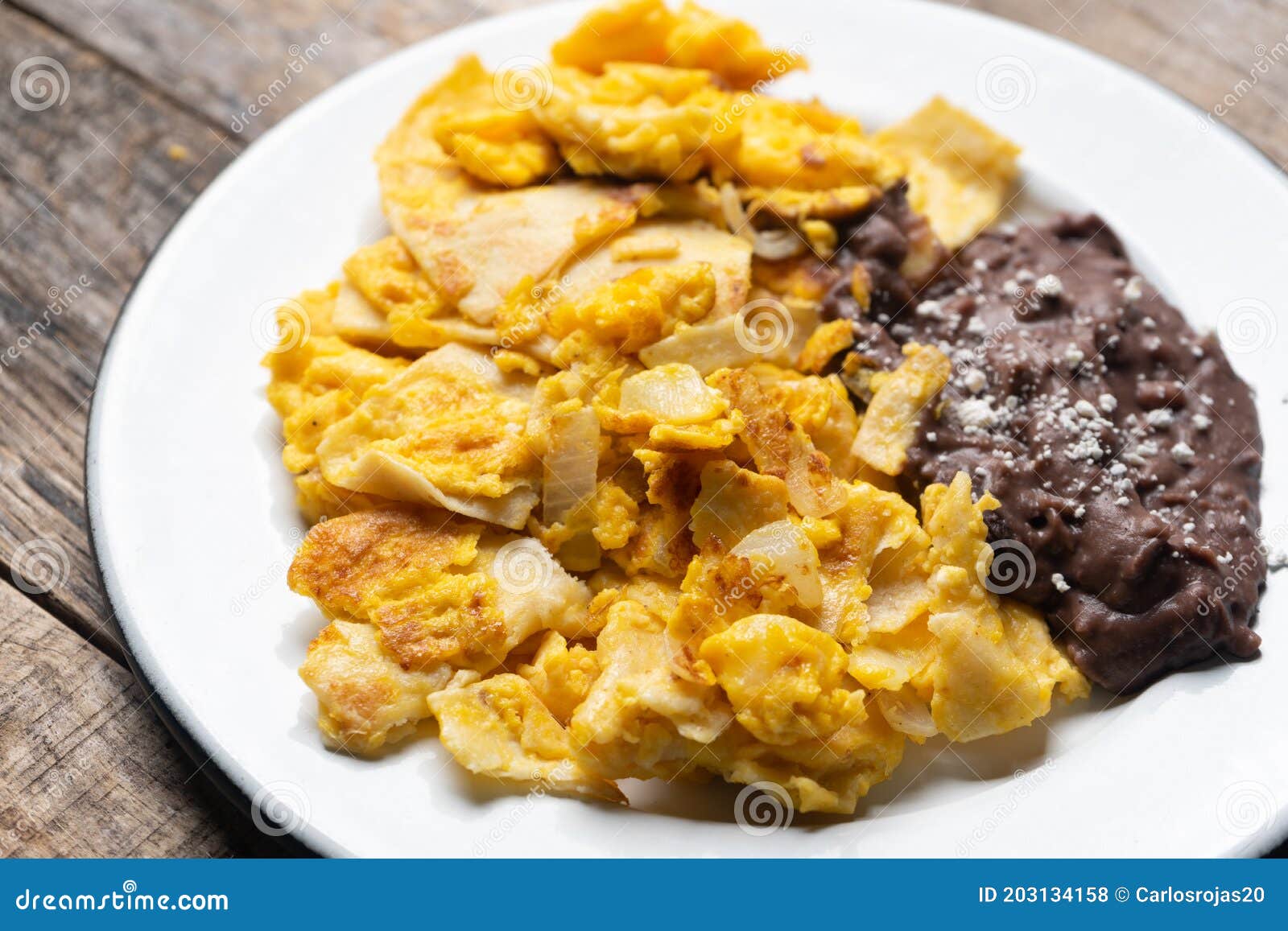 Mexican Scrambled Eggs with Corn Tortilla Also Called Migas on Wooden