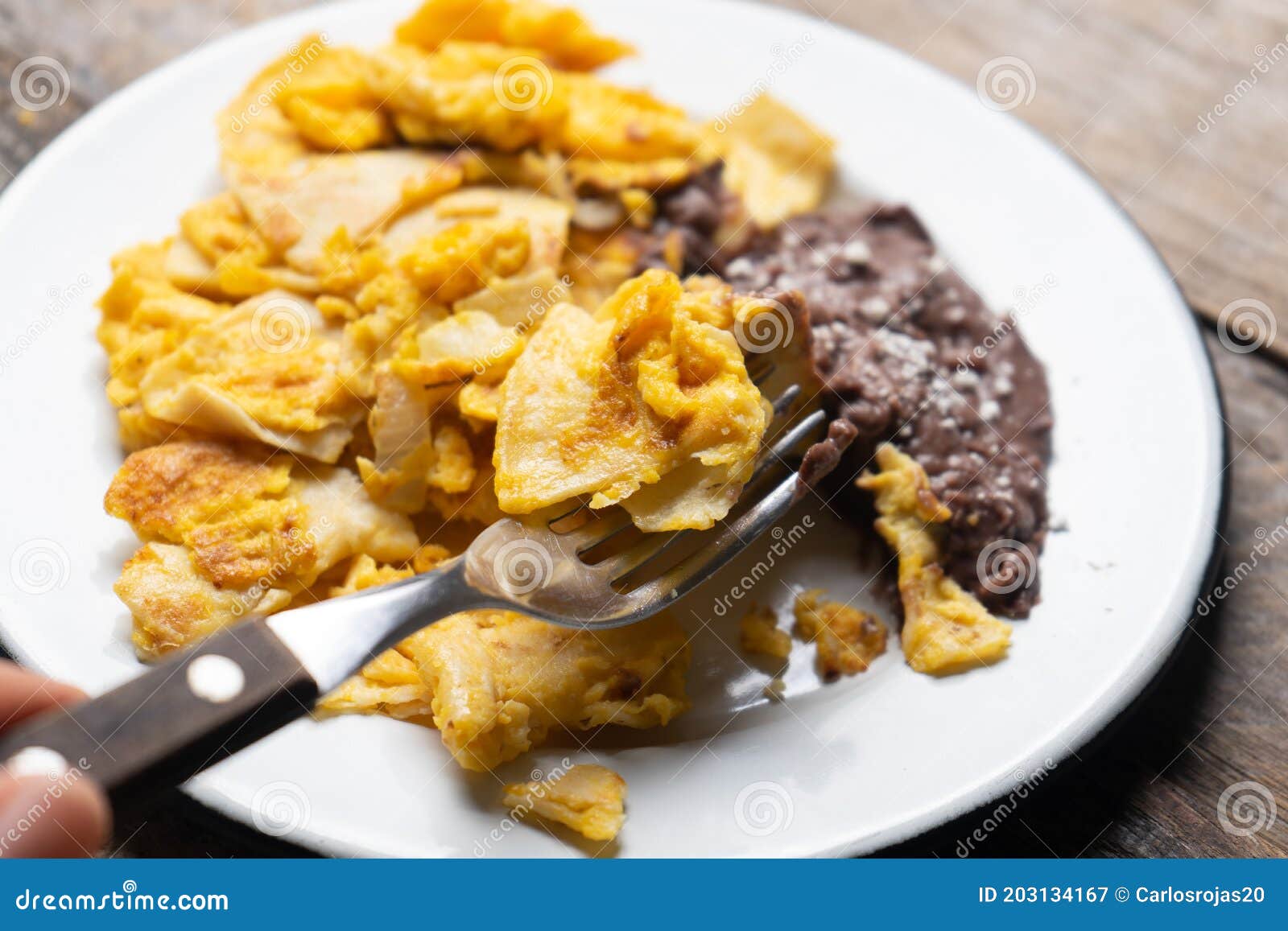 Mexican Scrambled Eggs with Corn Tortilla Also Called Migas on Wooden