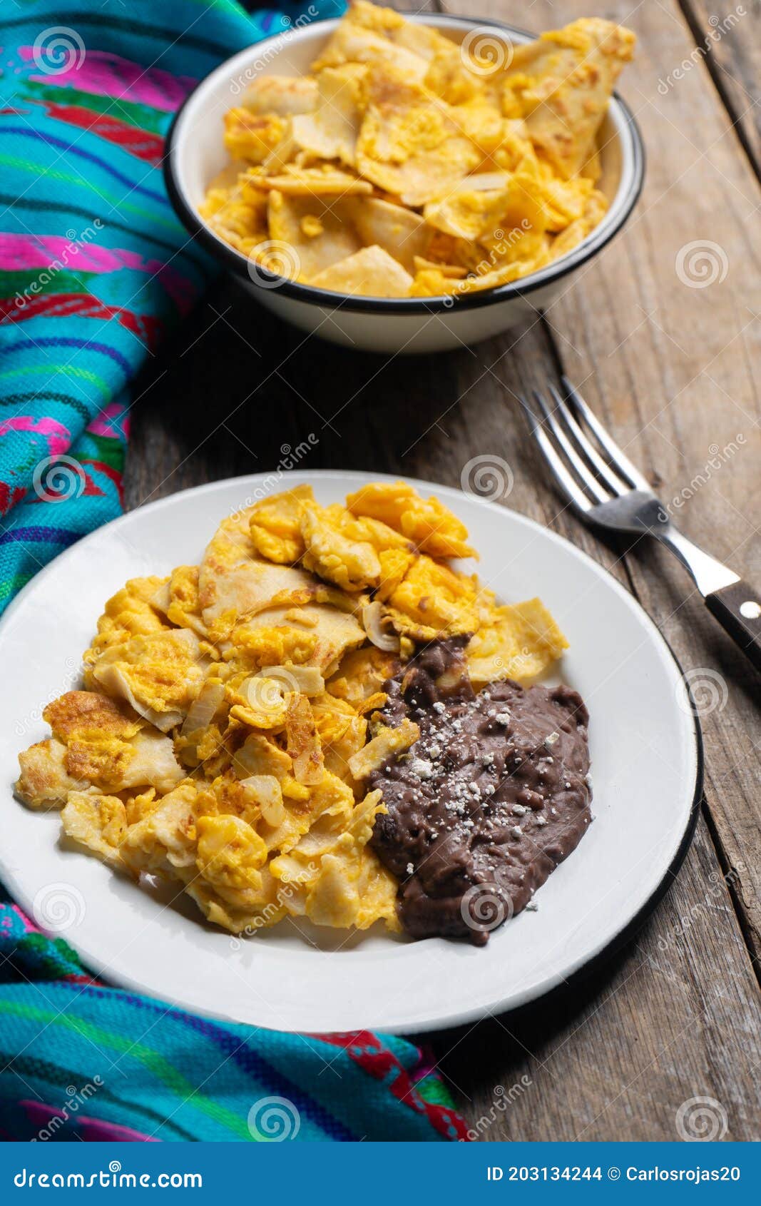 Mexican Scrambled Eggs with Corn Tortilla Also Called Migas on Wooden