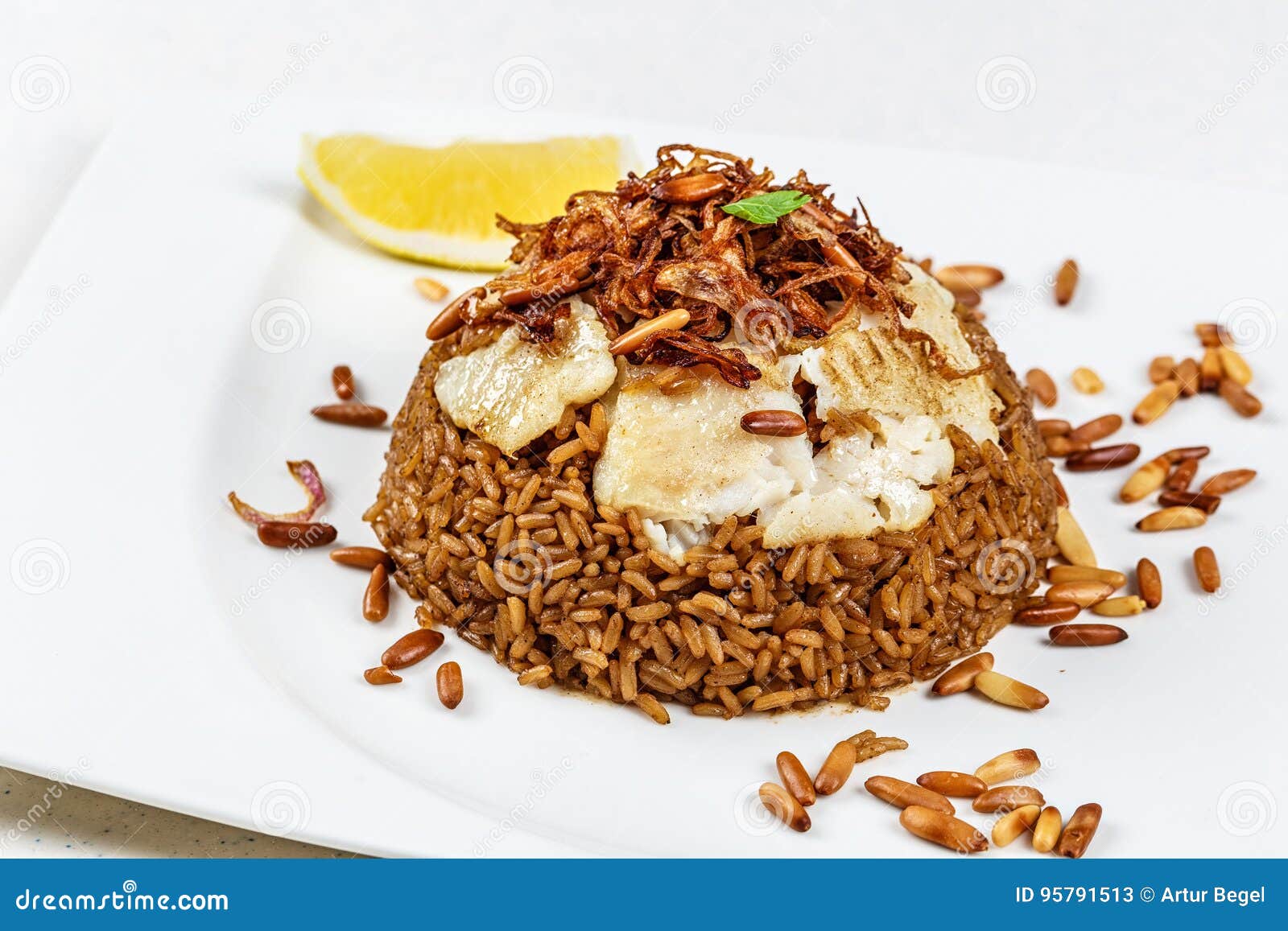 Traditional Middle Eastern Fish and Fried Rice Dish with Fried Pine