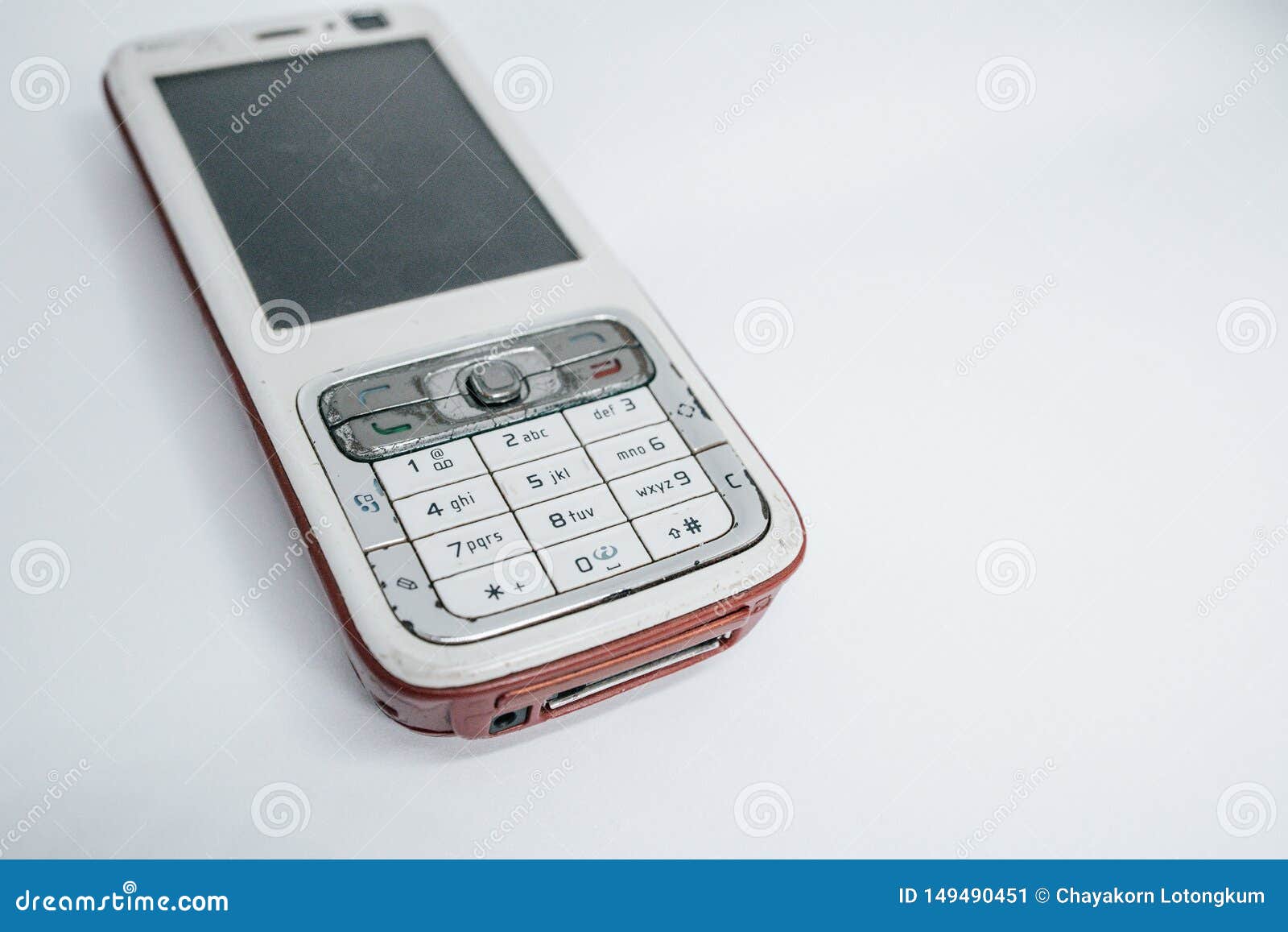 traditional mobile phone in second generation with keyboard button and mini black and white monitor by white isolate die cut backg
