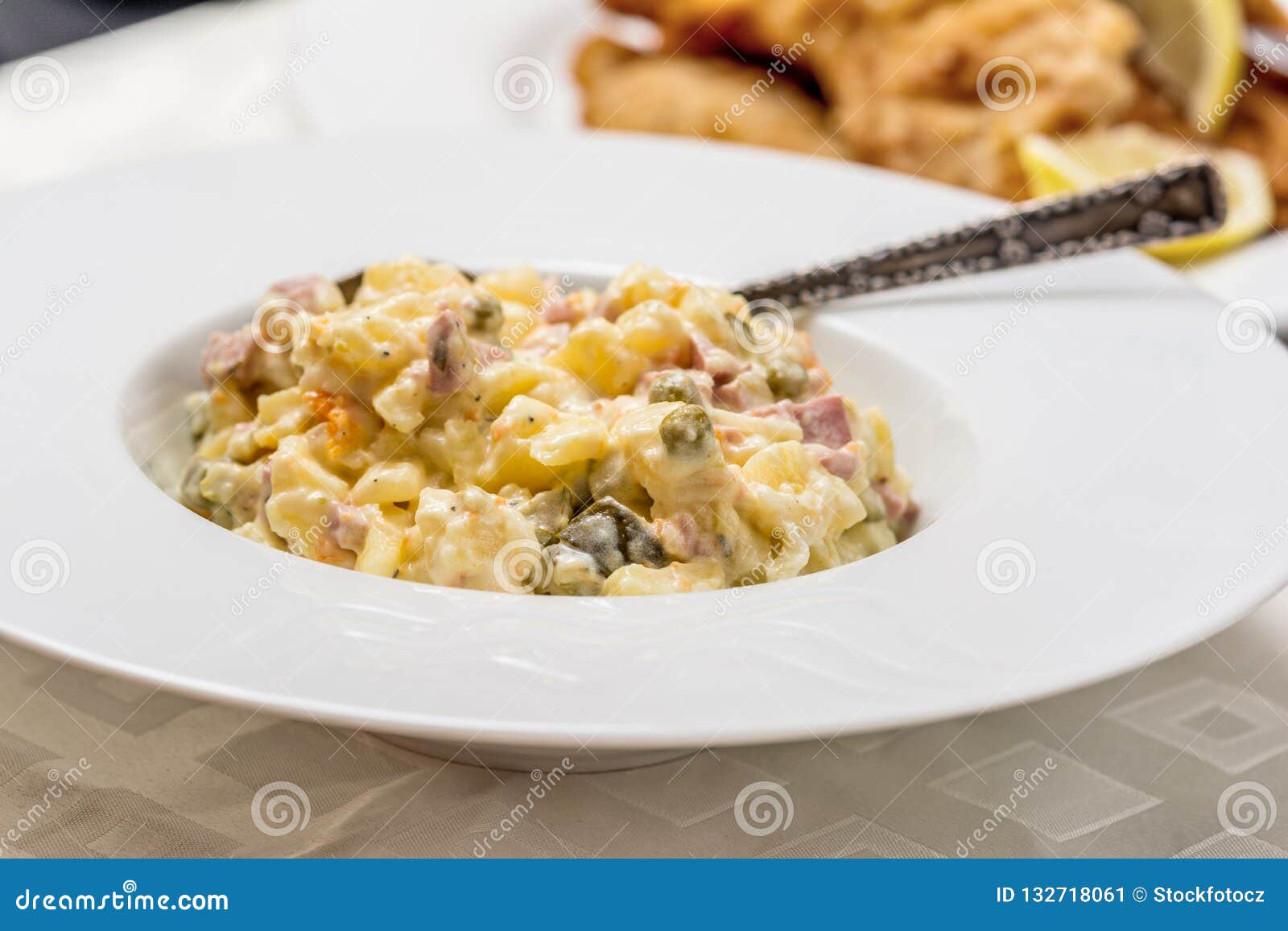 Traditional potato salad. Traditional czech potato salad with mayonnaise and vegetables in white plate