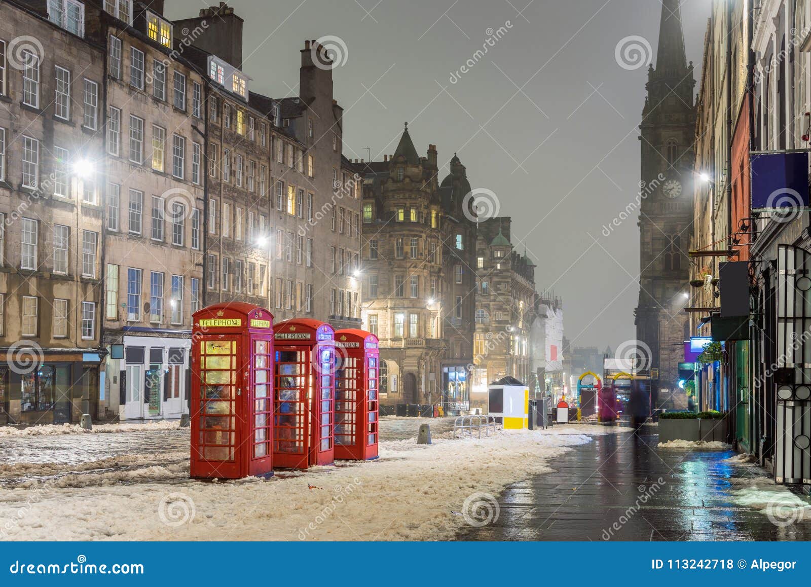 snow covered royal mile in edinburgh on a foggy winter day