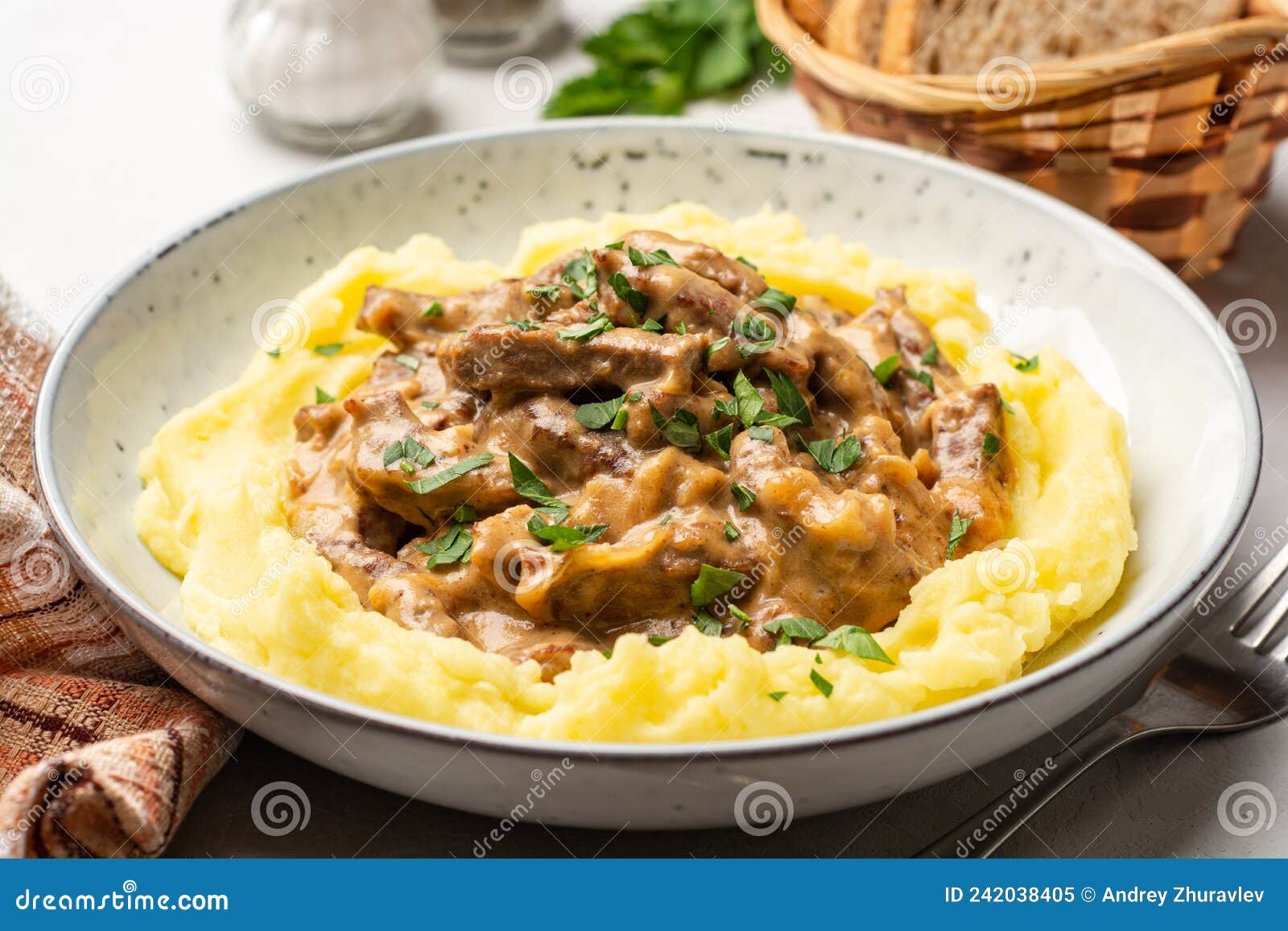 Traditional Russian Dish Beef Stroganoff with Mashed Potatoes in Plate on Concrete Background