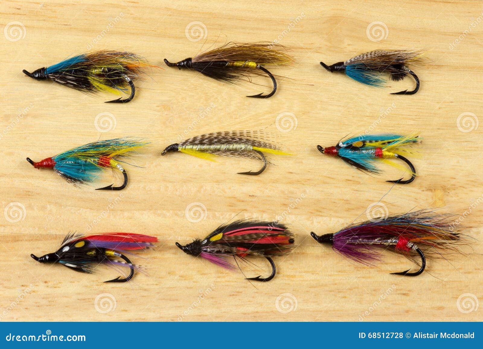 Traditional Salmon Fishing Flies on a Wooden Background Stock