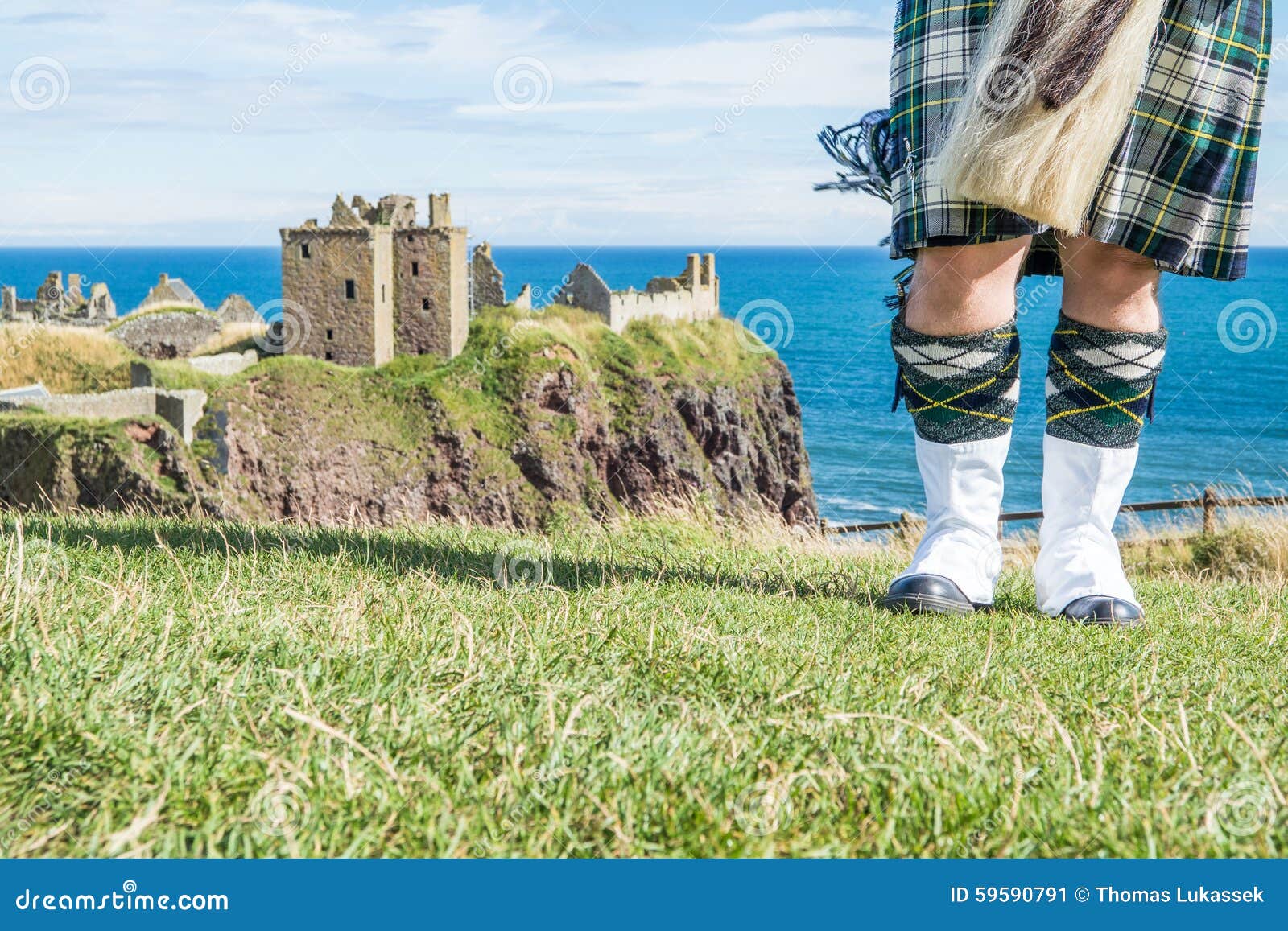 Traditional Scottish Bagpiper in Full Dress Code at Dunnottar Castle