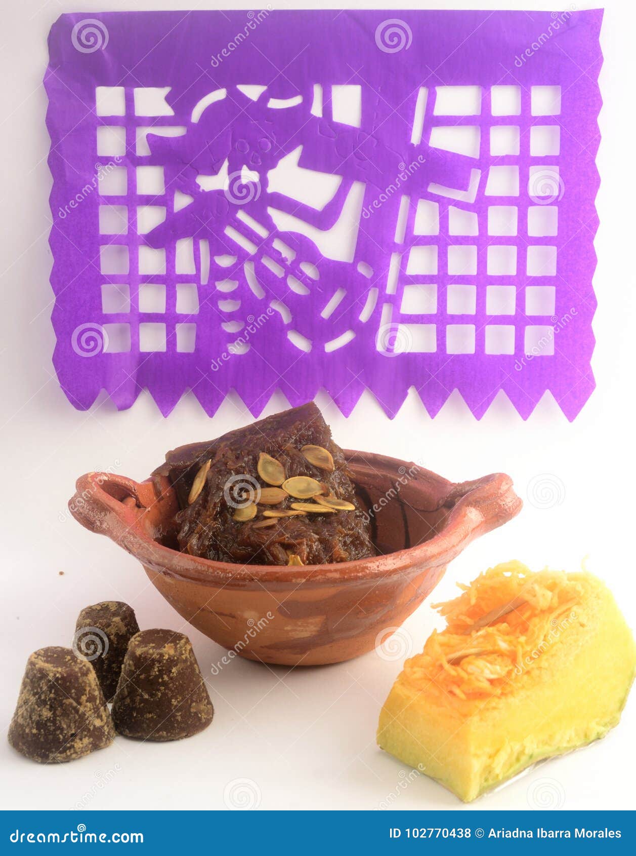 mexican traditional pumpkin sweet made with piloncillo and cinammon on a clay pot, known as calabaza en tacha with decoration