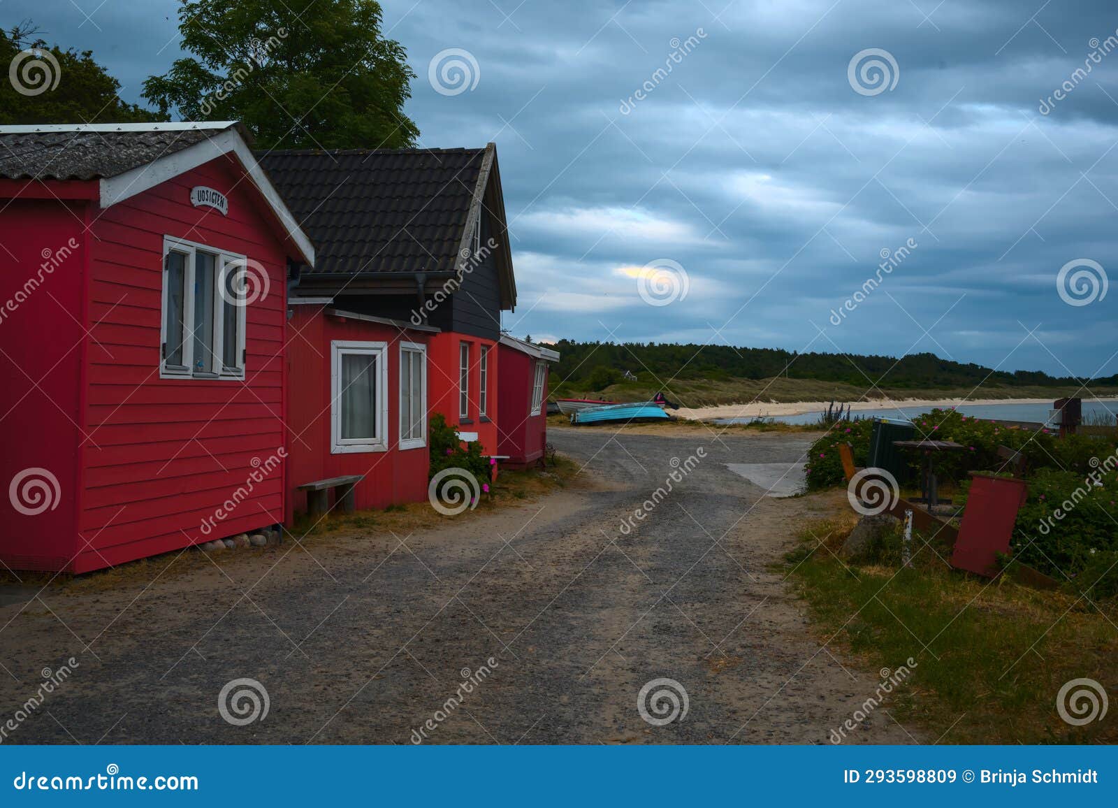 a traditional small,red,danish framehouse in summer in bornholm with blue sky