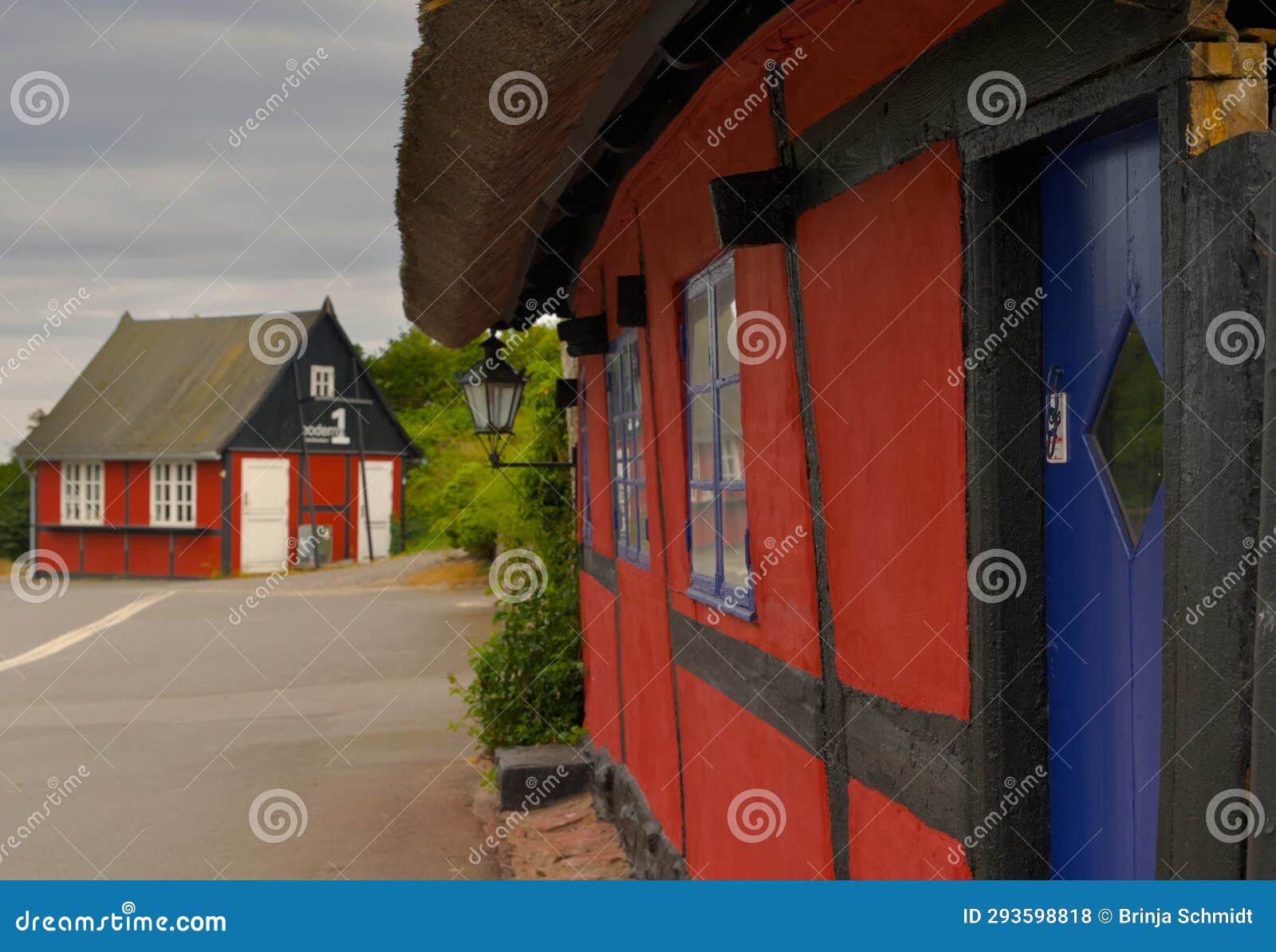 a traditional small,red,danish framehouse in summer in bornholm with blue sky