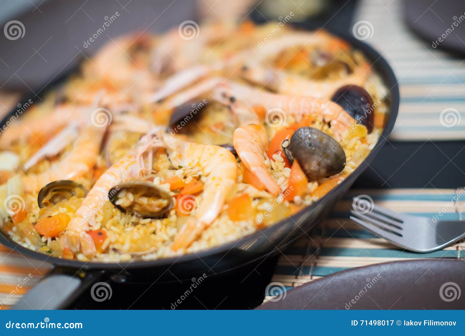 Traditional Spanish rice dish with seafood - paella. Delicious Valencian rice dish with seafood paella close up