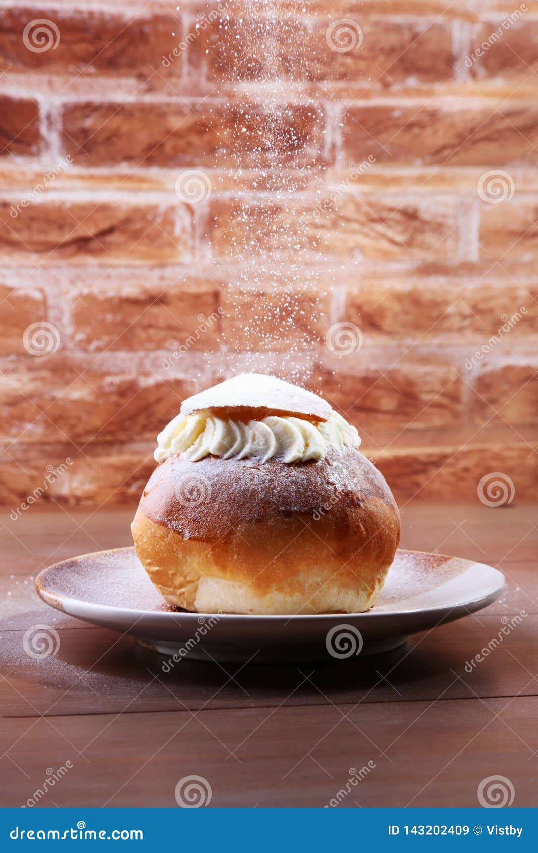 traditional swedish dessert semla, also called shrove bun, with almond paste and whipped cream filling.
