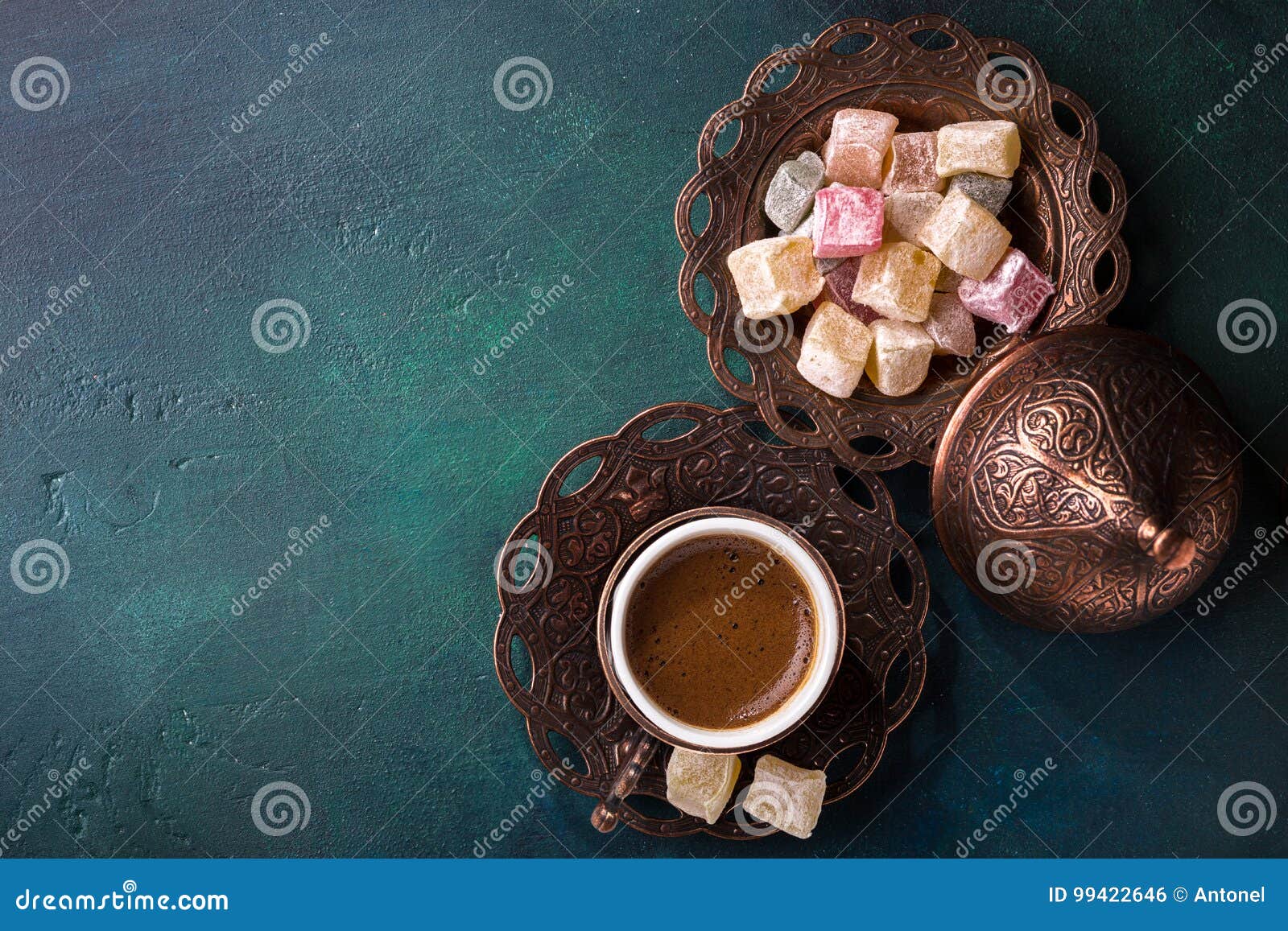 traditional turkish coffee and turkish delight on dark green wooden background. flat lay