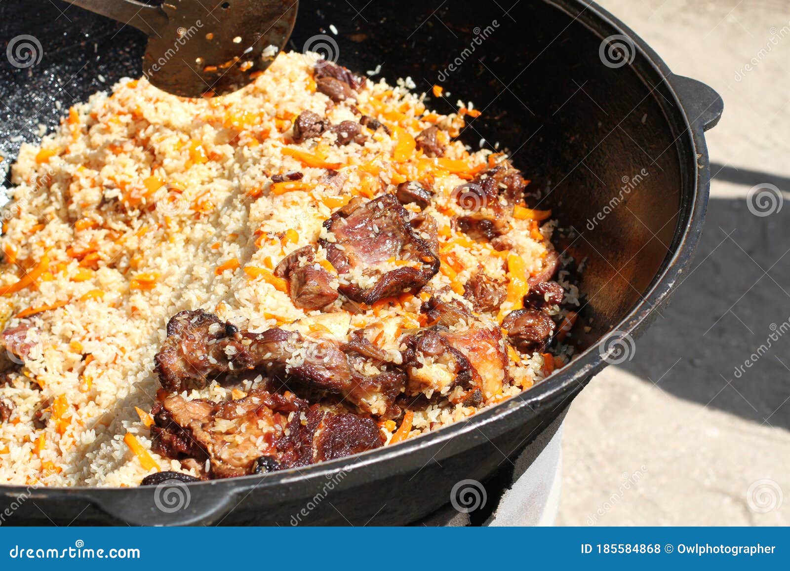Traditional Uzbek Pilaf with Lamb Meat Cooked in a Large Stock Photo