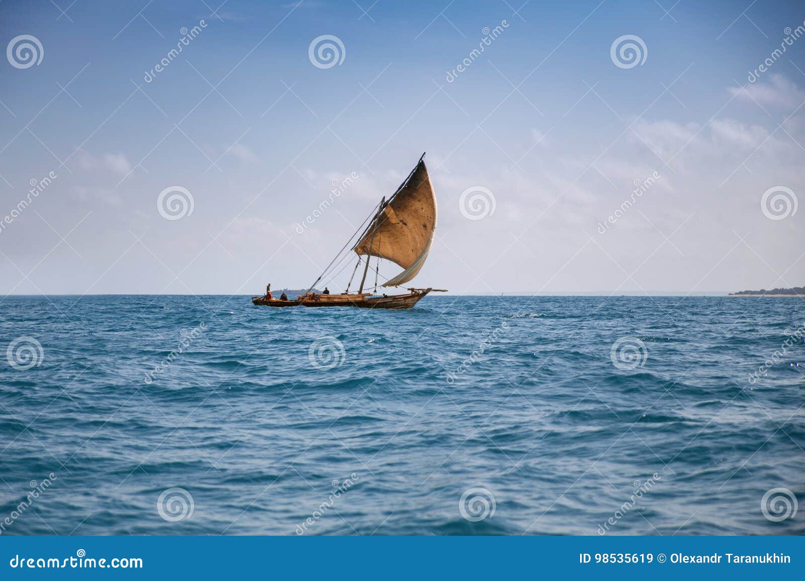 traditional zanzibar boat dhow sailing in the sea