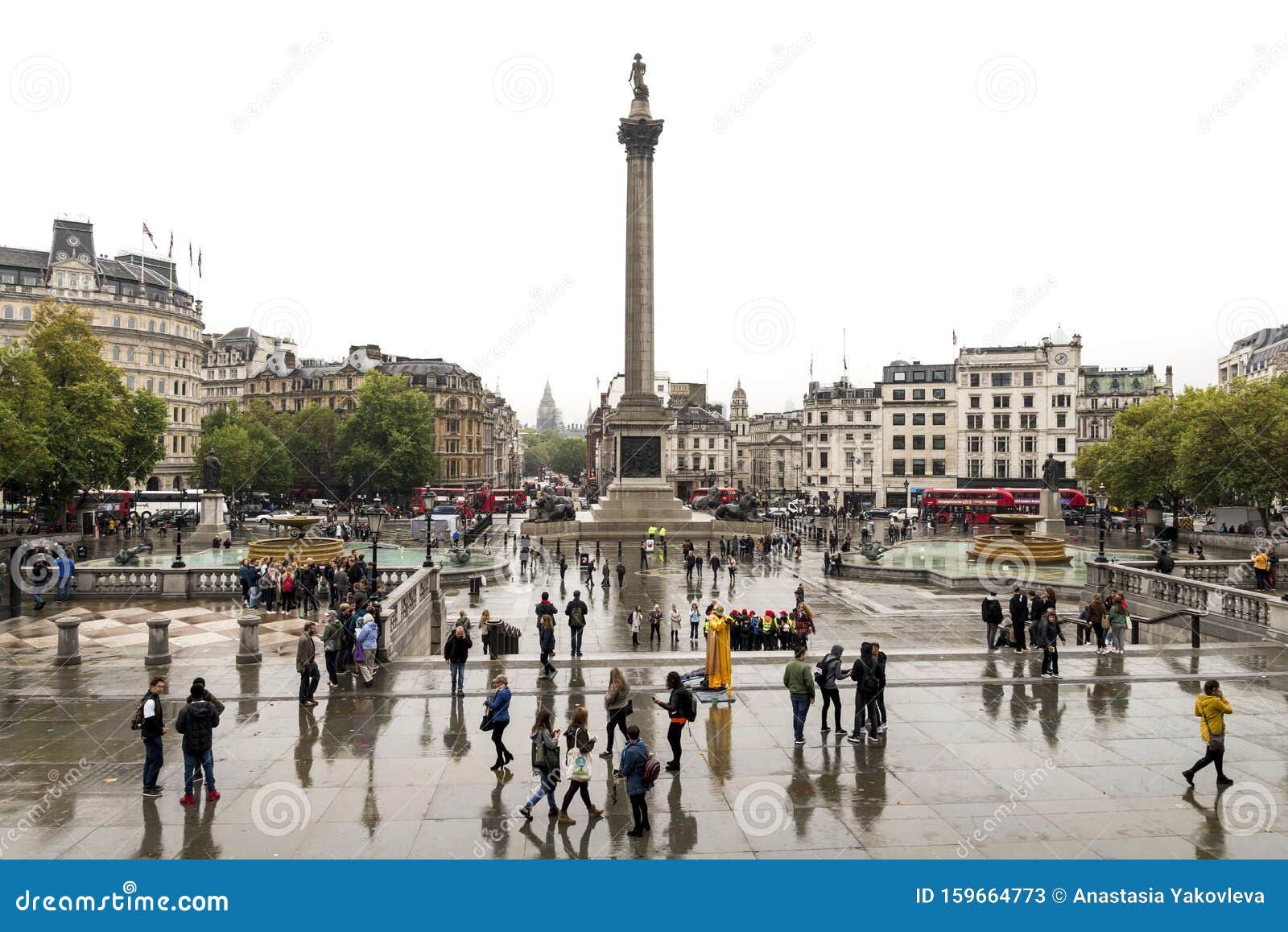 Trafalgar Square and Tourists after Rain in Autumn Season, London