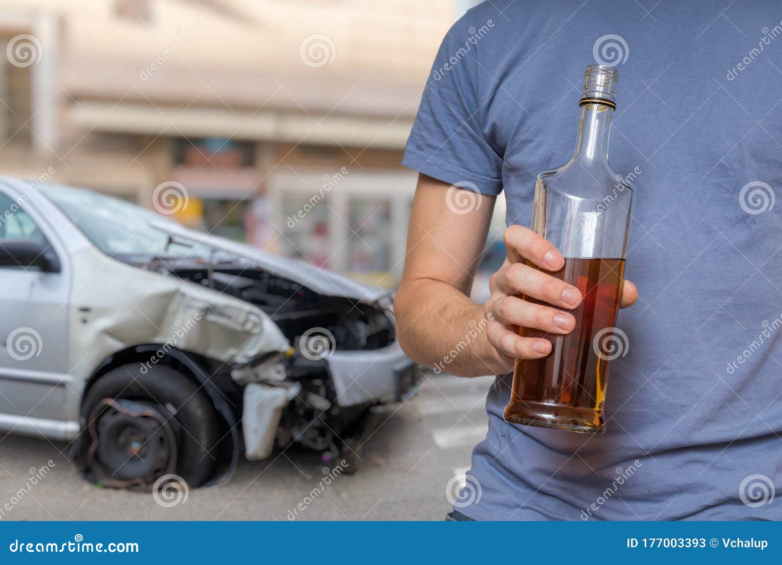 Traffic Accident and Alcohol Concept. Drunk Driver is Holding Bottle