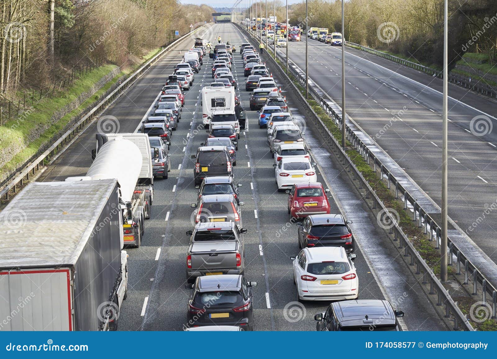 emergency services closing motorway to attend accident causing a traffic jam