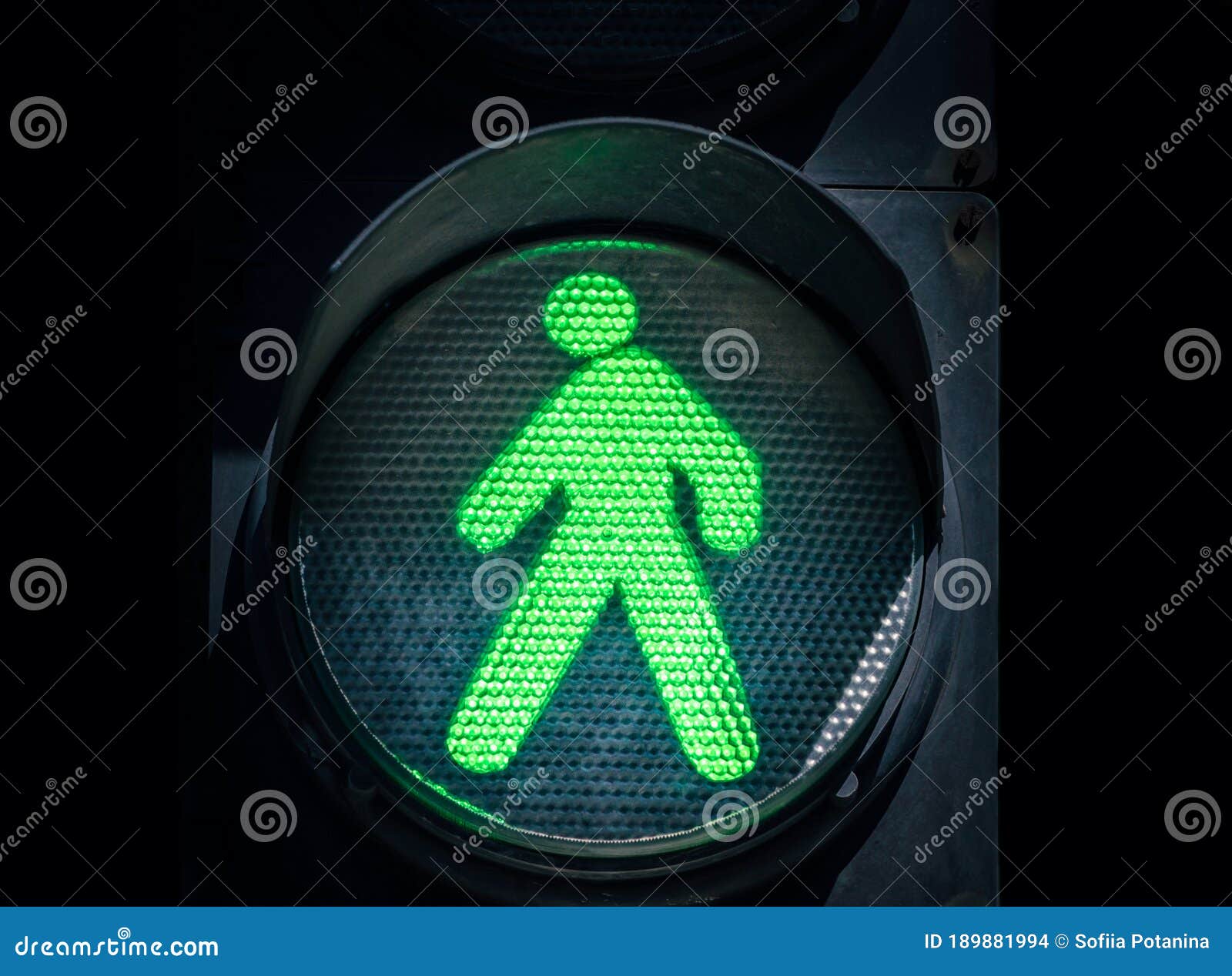 Traffic Light with a Green Man on a Black Background Stock Photo