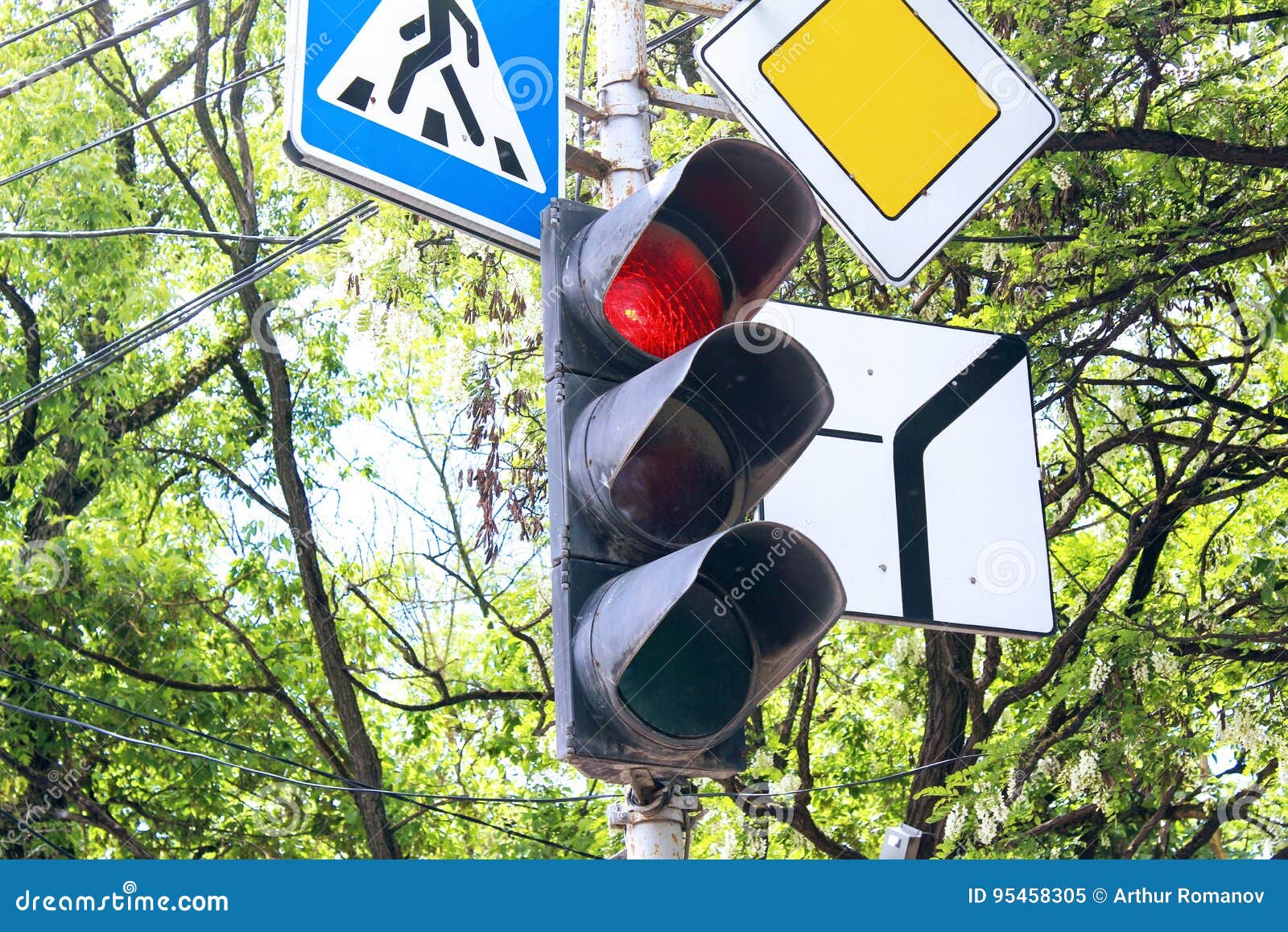 Traffic Light and Three Road Signs Regulating the Traffic. Stock Image