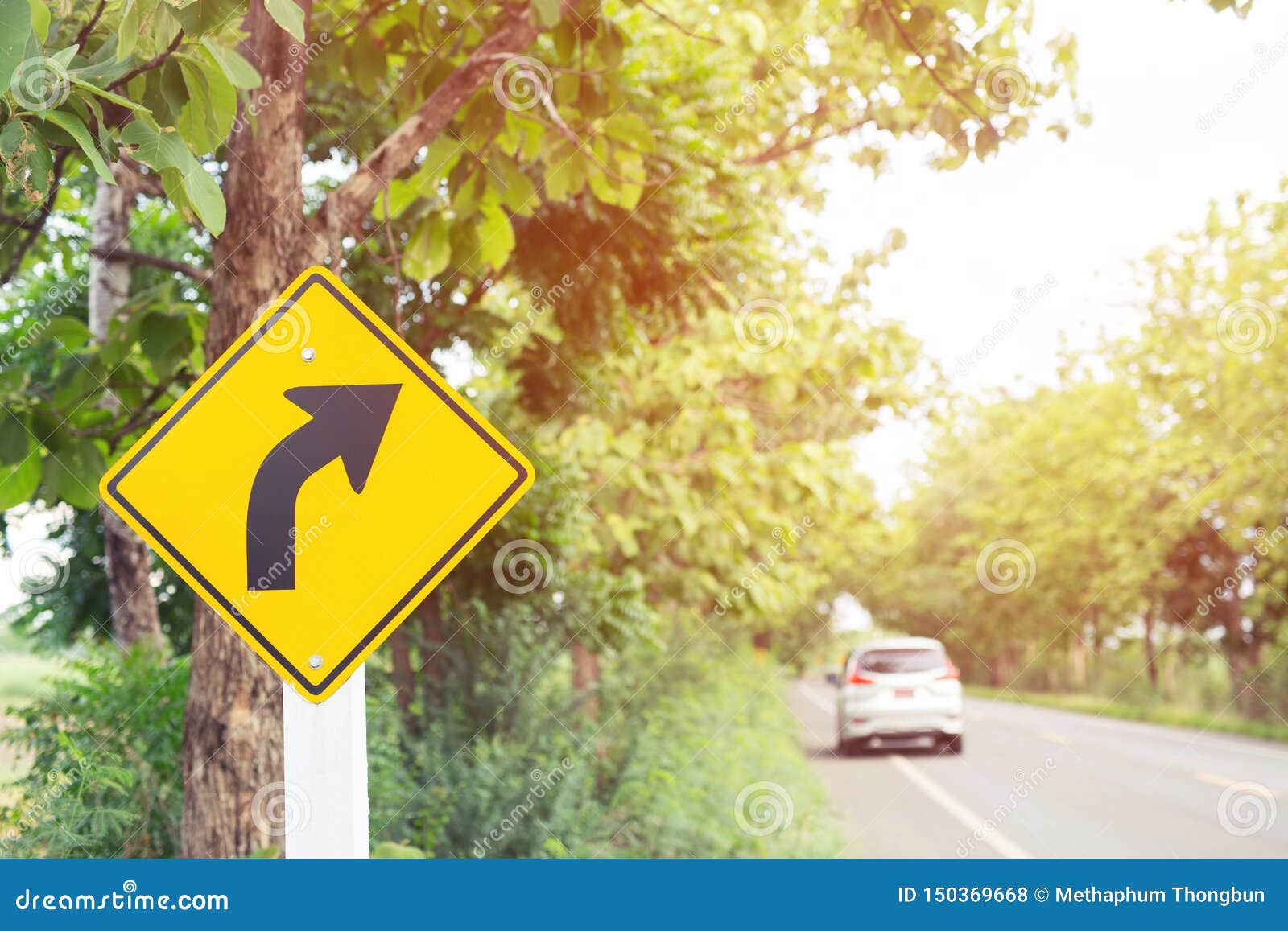 traffic sign placed beside along the road on route twisty winding slope. background driver car