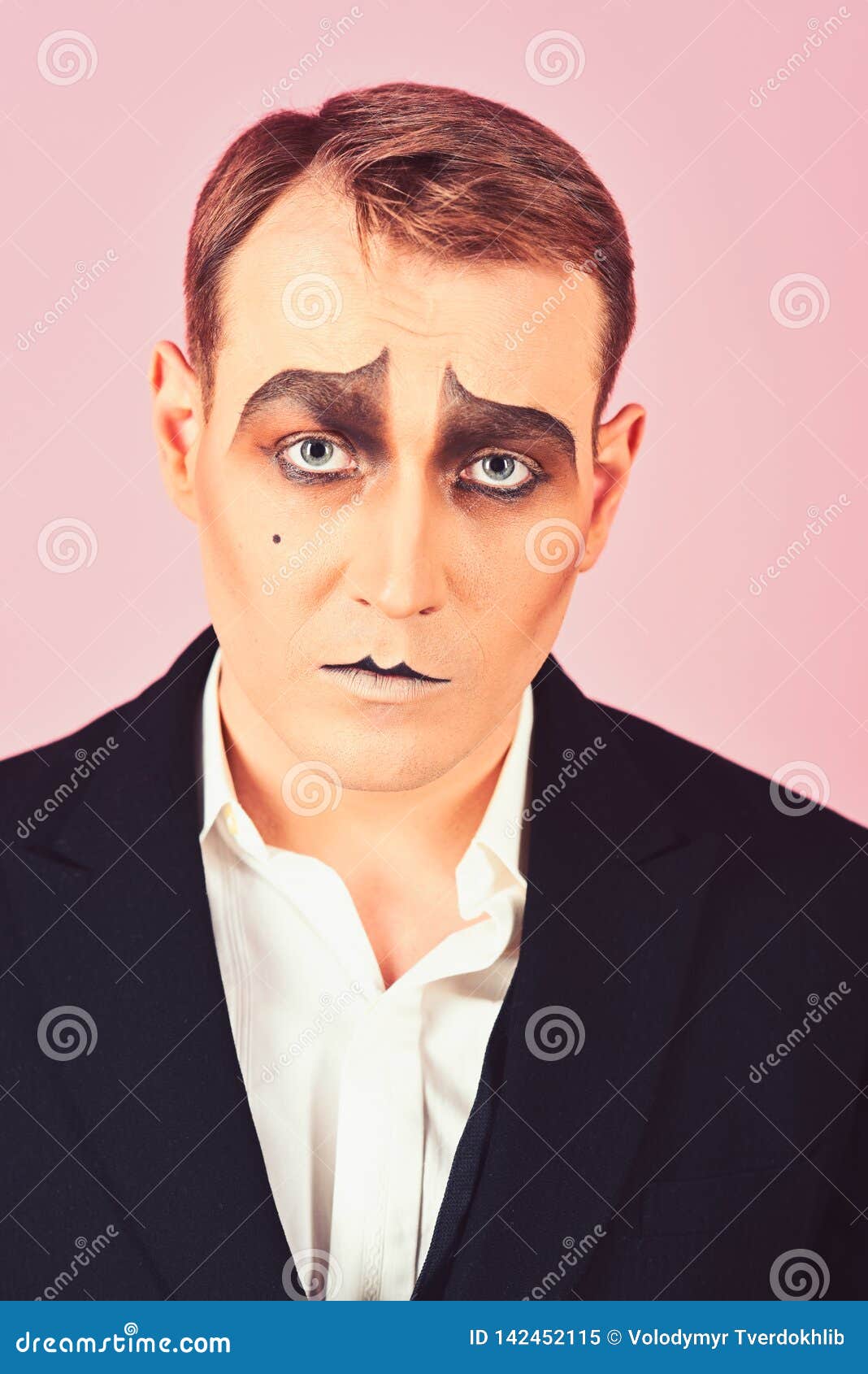 tragical actor. man with mime makeup. mime artist. mime with face paint. theatre actor miming. stage actor miming