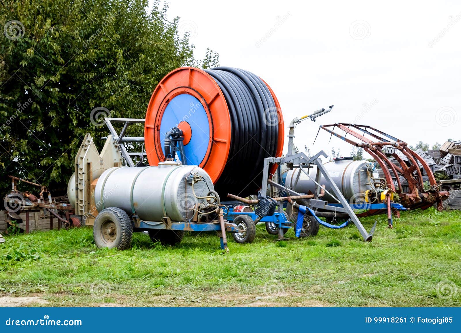 Trailers with Fertilizer Tanks and a Drum with a Watering Hose. Stock