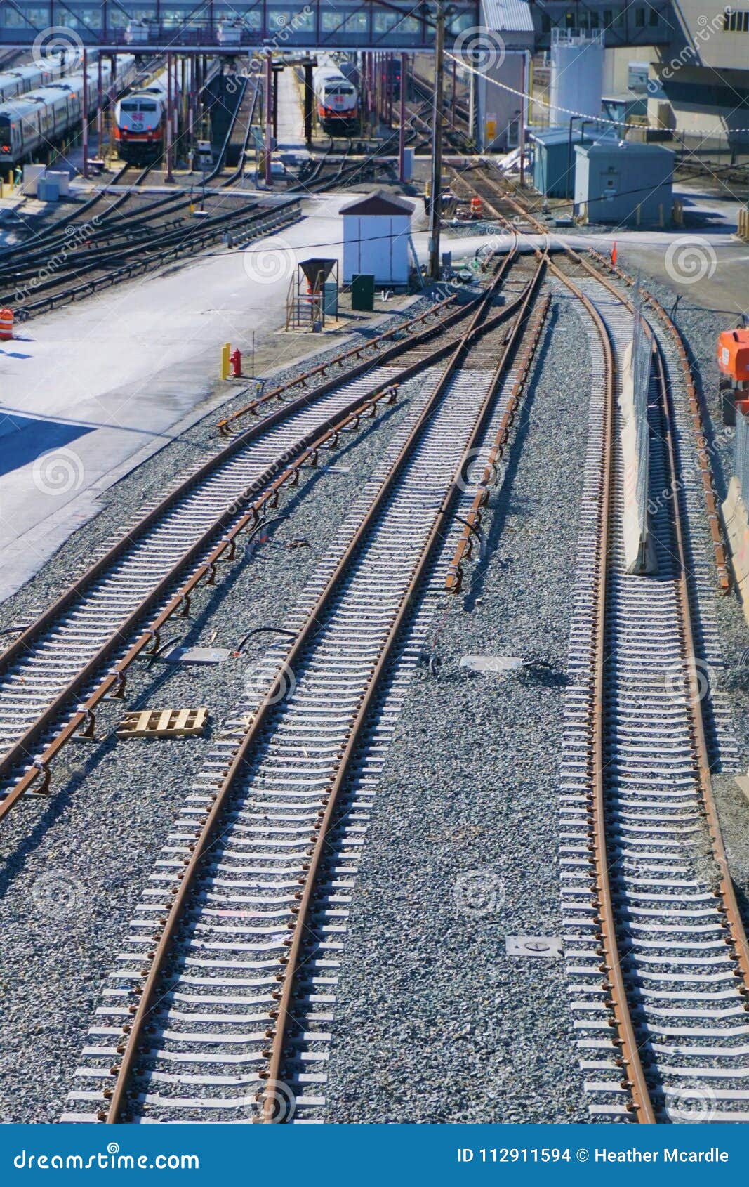 Train Tracks Merge and Divide at Active Train Station Stock Photo
