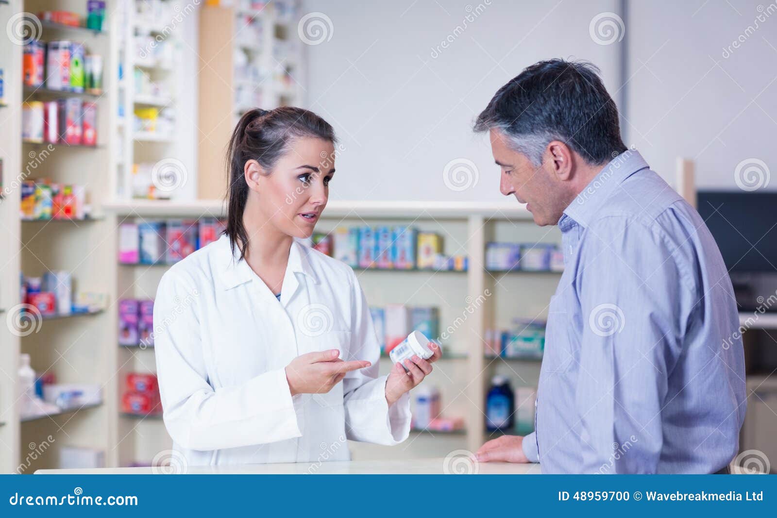 Trainee and Her Customer Talking about Medication Stock Photo Image