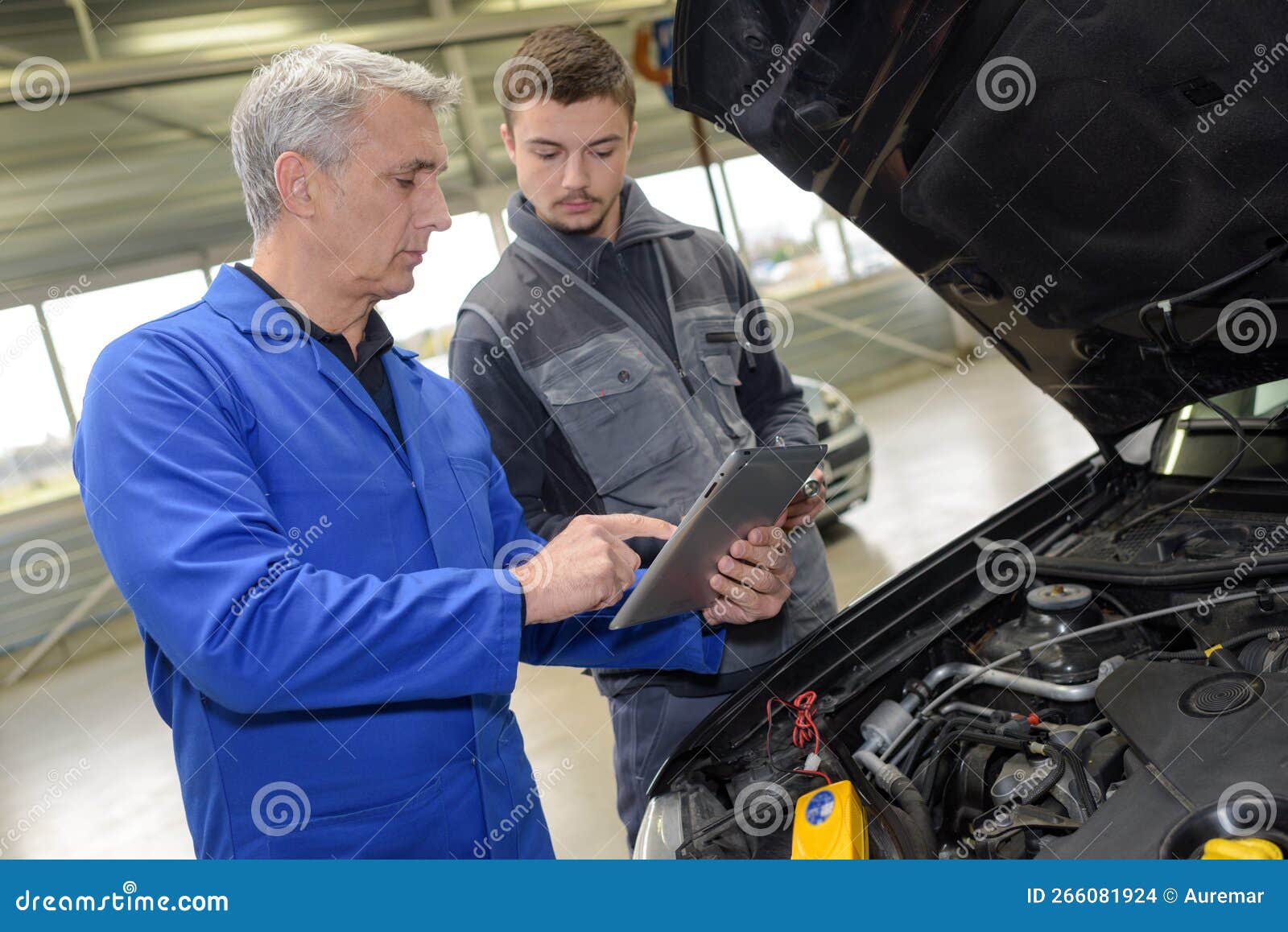 Trainee mechanic at work stock photo. Image of female 266081924