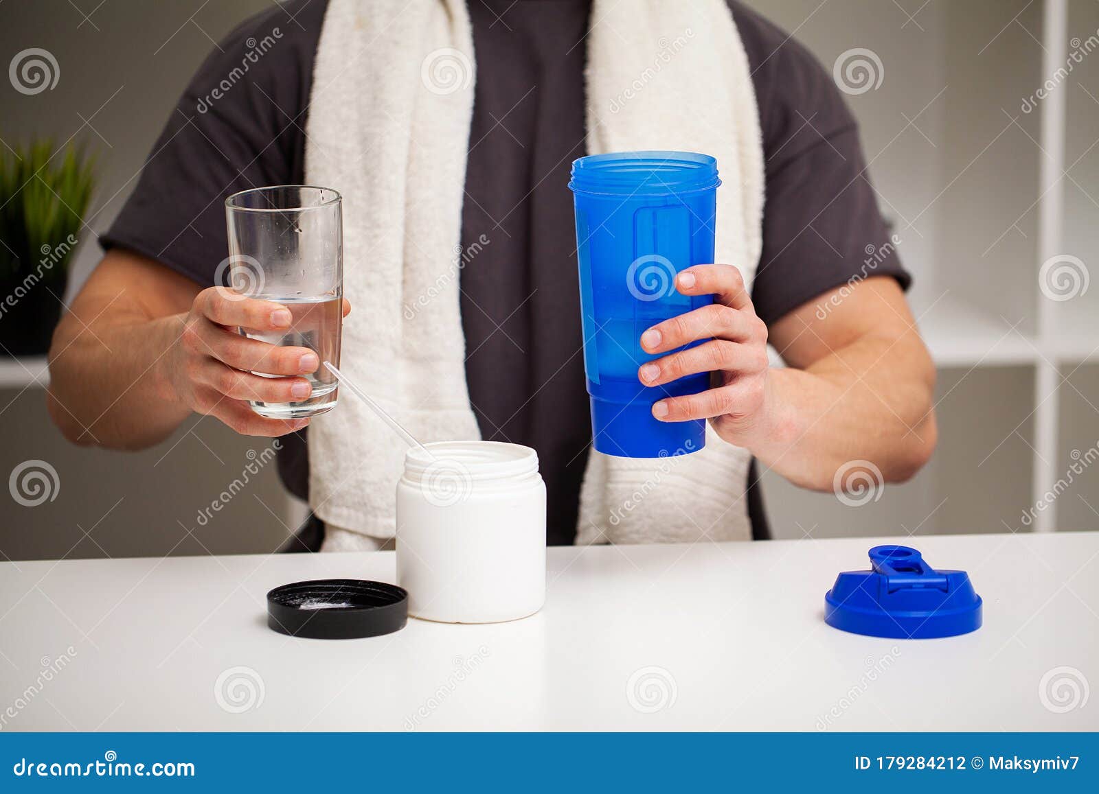 Trainer Prepares a Protein Shake in the Shaker after Training. Stock