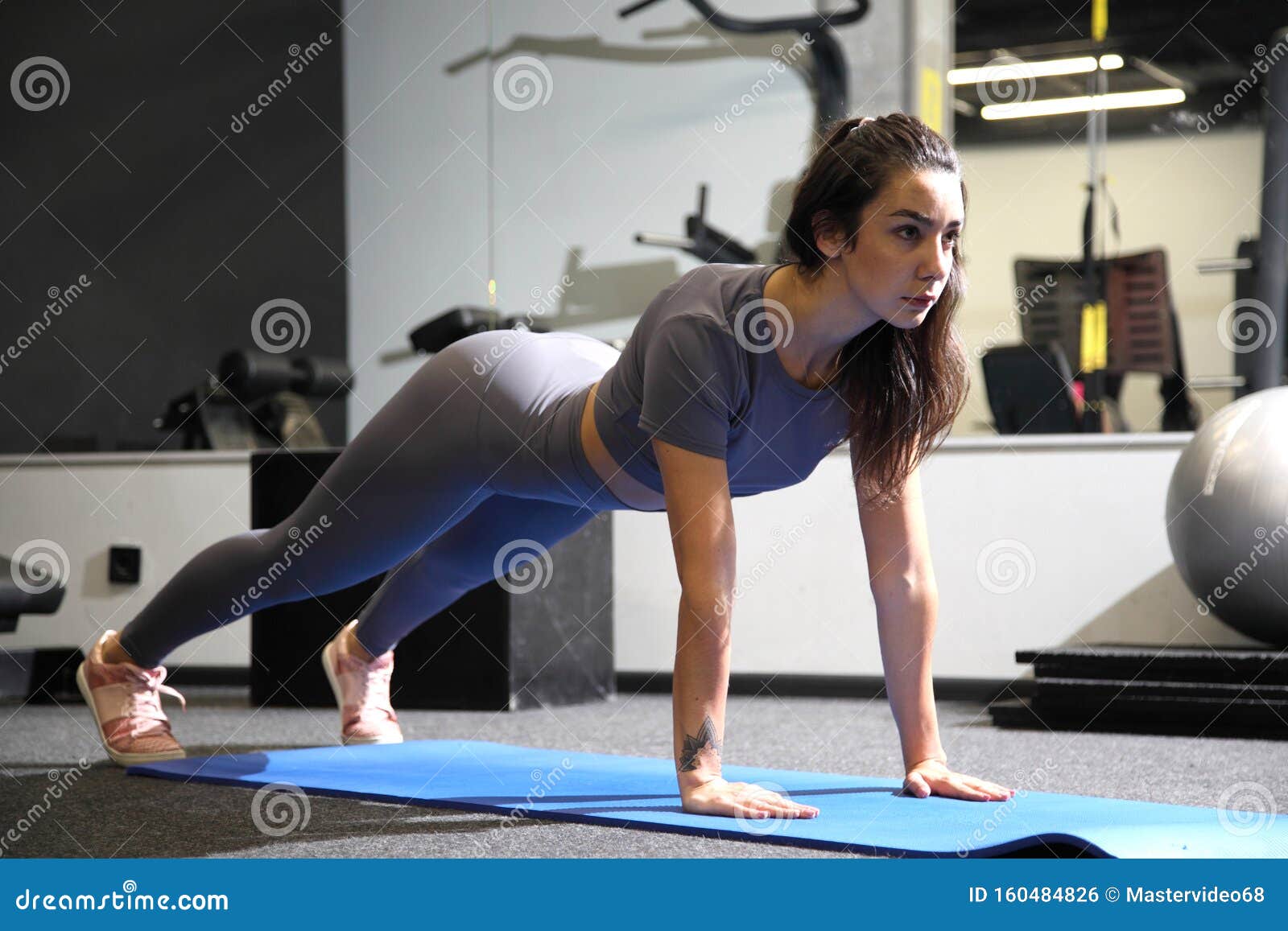 Young Girl Doing Fitness Exercises in the Gym. Training in the Gym