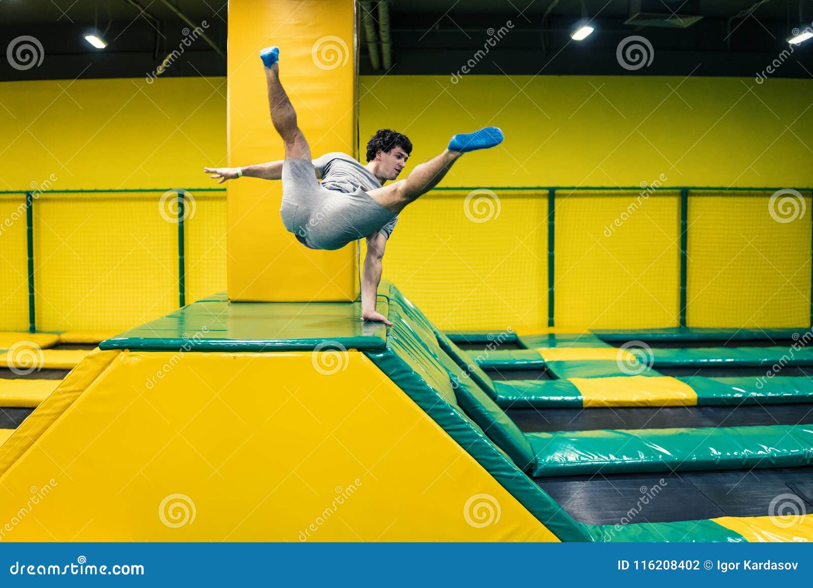 Trampoline Jumper Performs Acrobatic Exercises on the Trampoline Stock