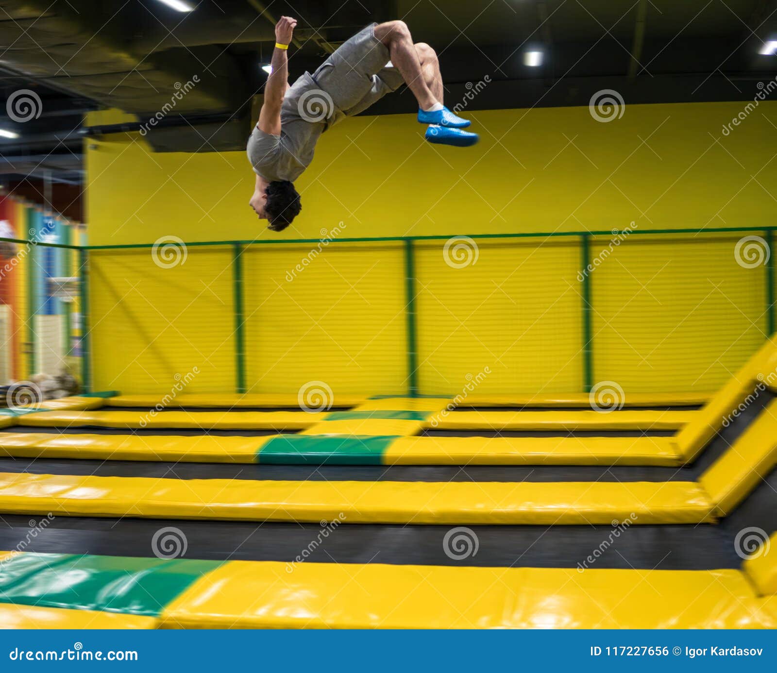Trampoline Jumper Performs Acrobatic Exercises on the Trampoline Stock