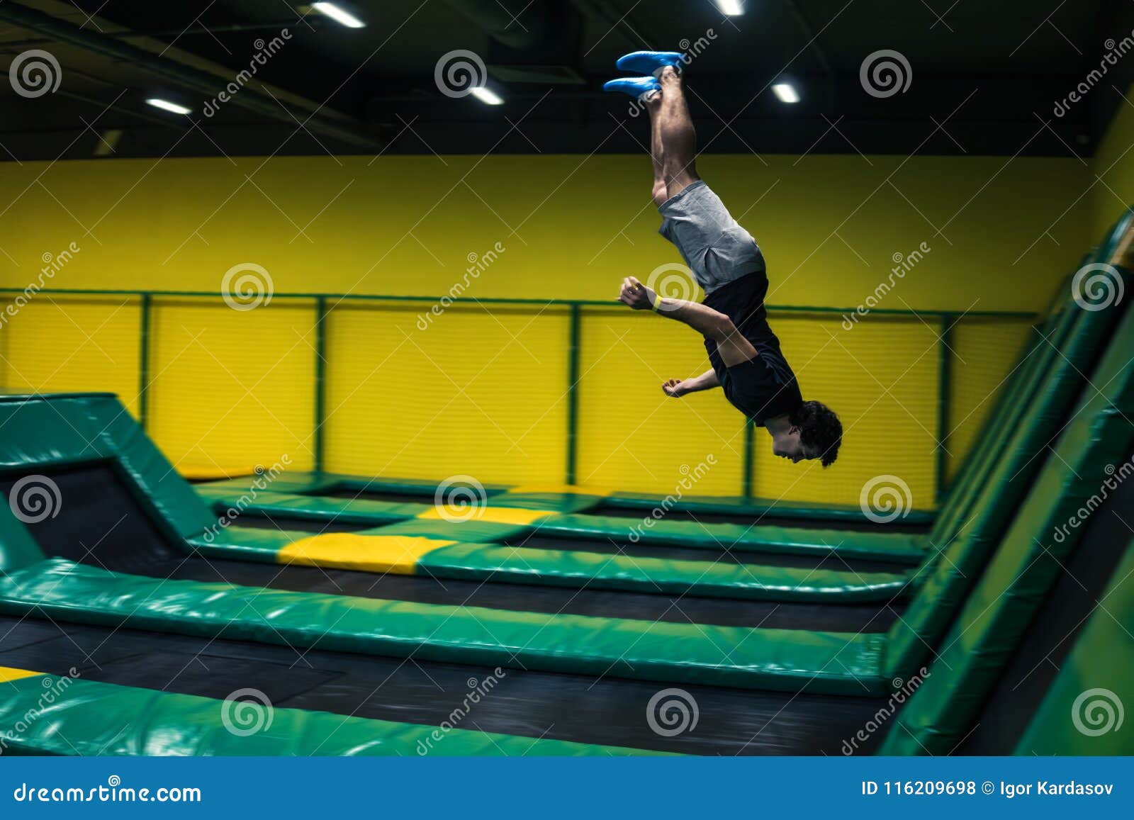 Trampoline Jumper Performs Acrobatic Exercises on the Trampoline Stock
