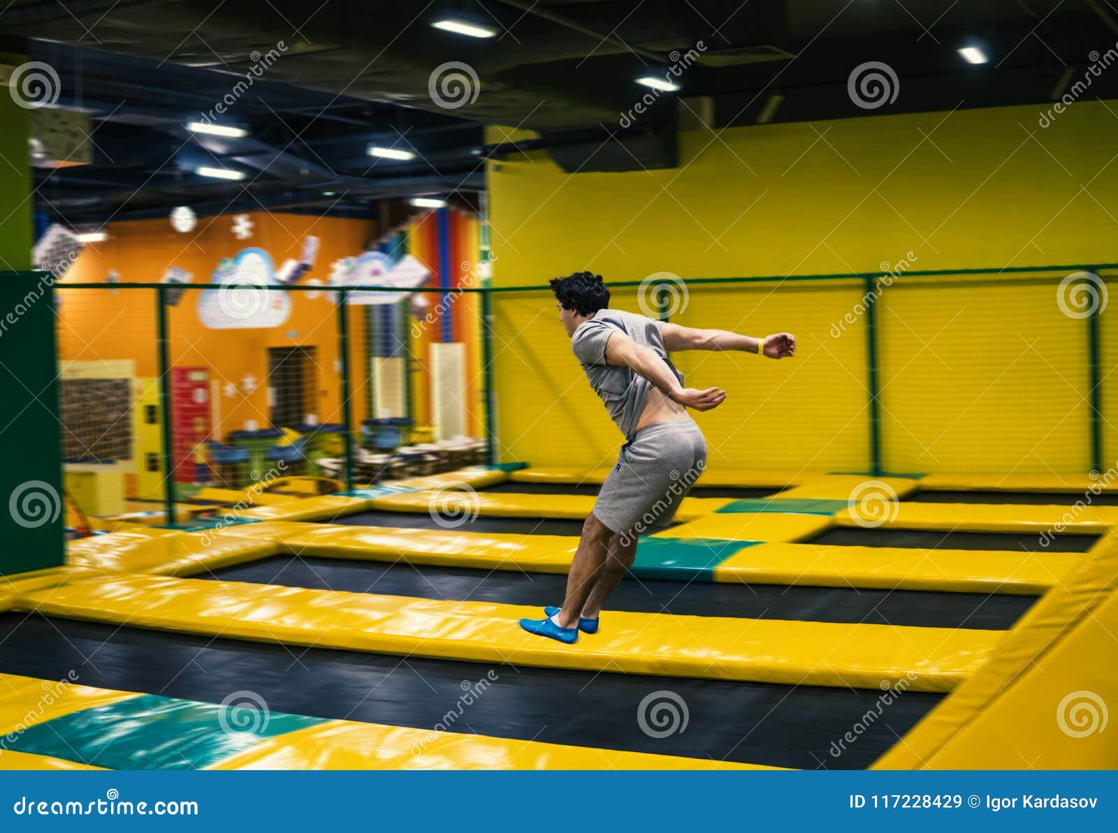Trampoline Jumper Performs Acrobatic Exercises on the Trampoline Stock