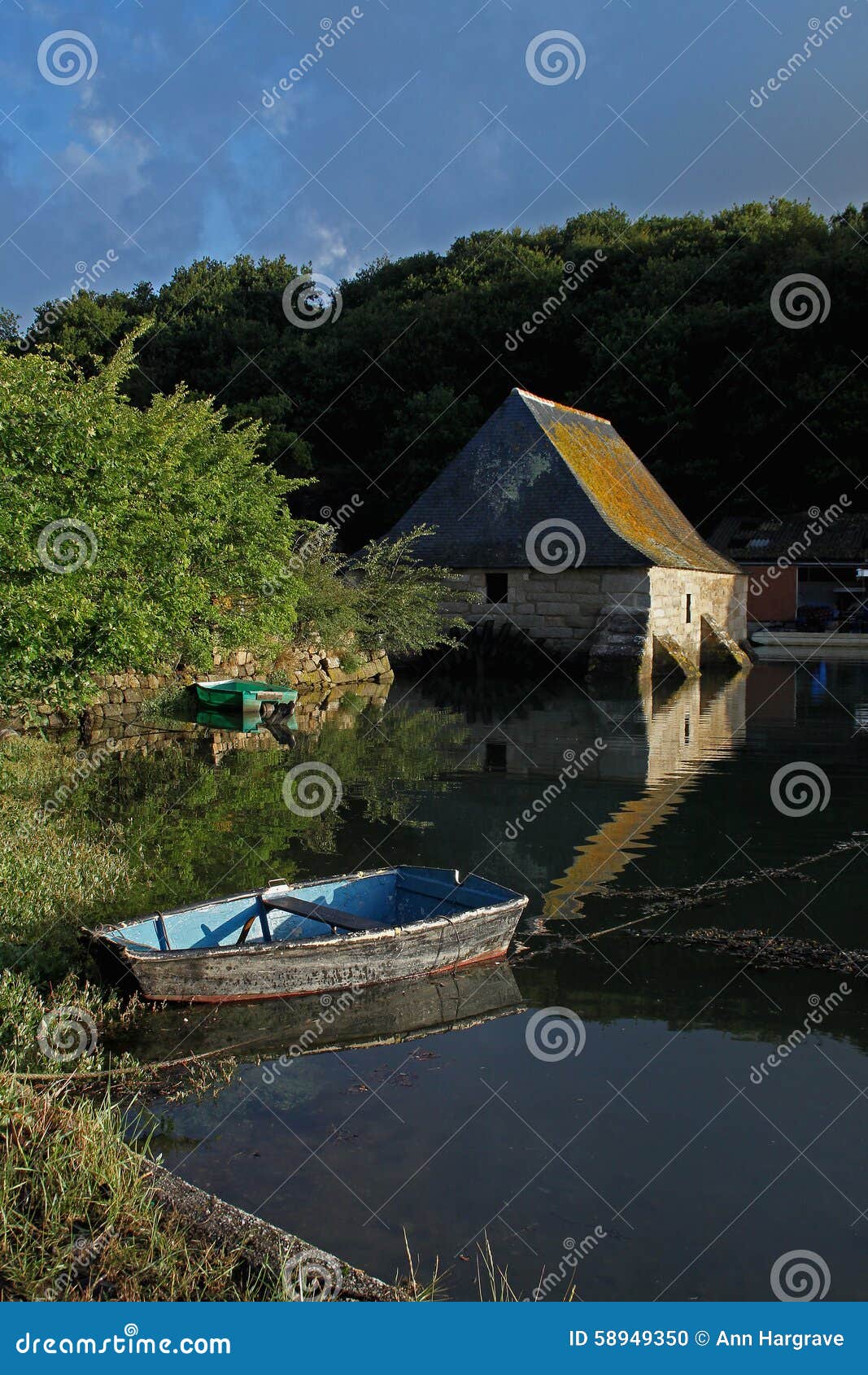 Tranquil early morning, at Henant, Brittany, France. Calm early morning scene at Henant, Brittany, France with old storage building.