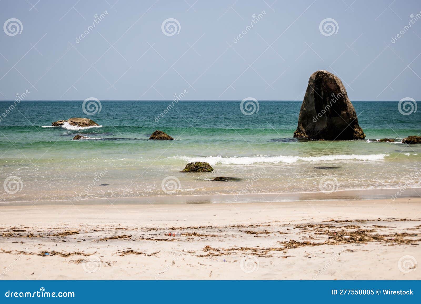 tranquil sea with rocks at black beach, praia preta, brazil.