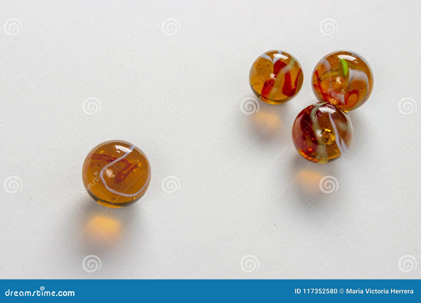 Glass marbles over white background