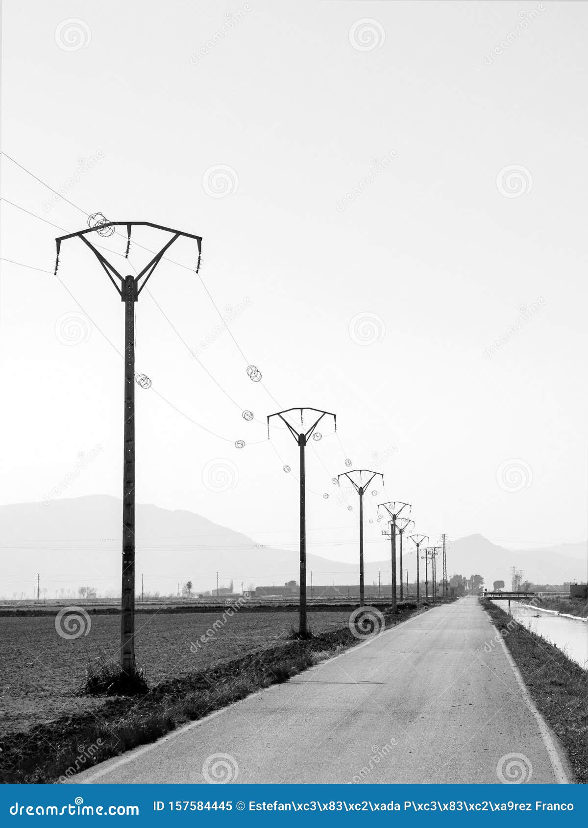 transmission towers, power posts near a road