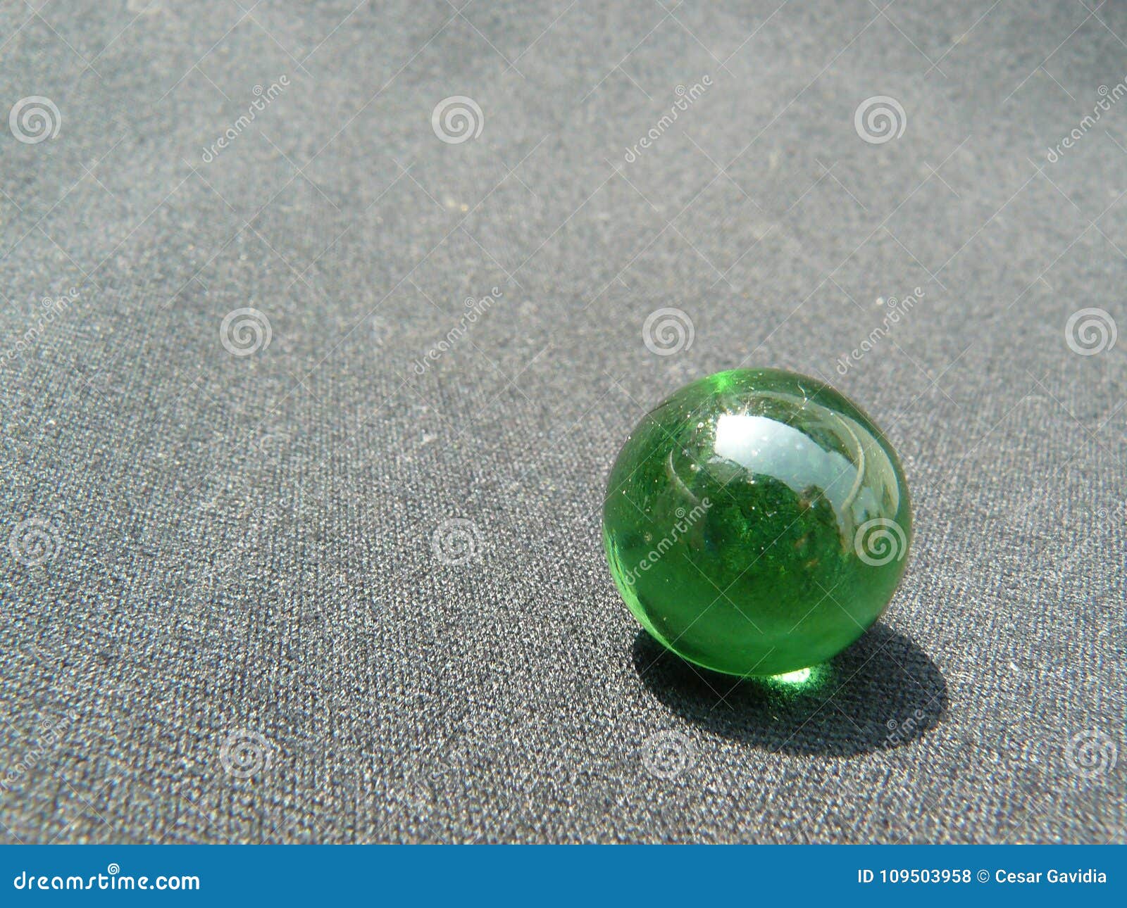 transparent and green glass marble