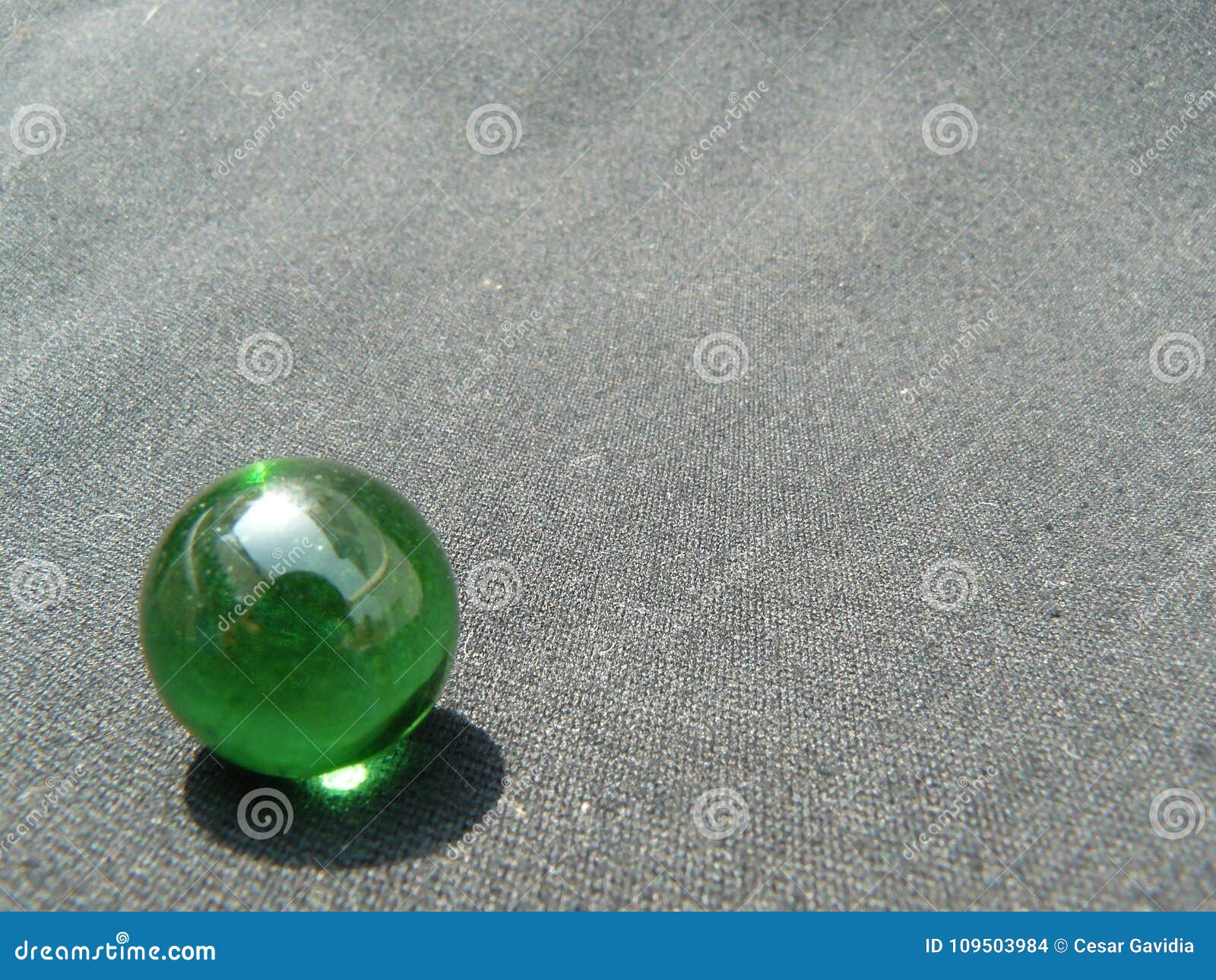 transparent and green glass marble