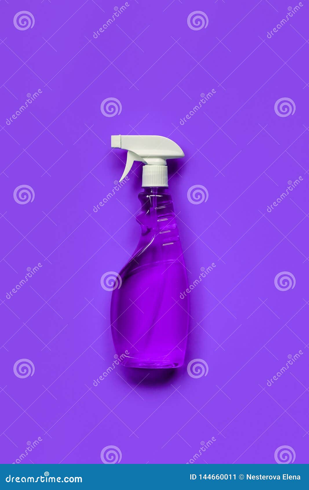 Transparent Purple Spray Bottle with Window Cleaner on Purple