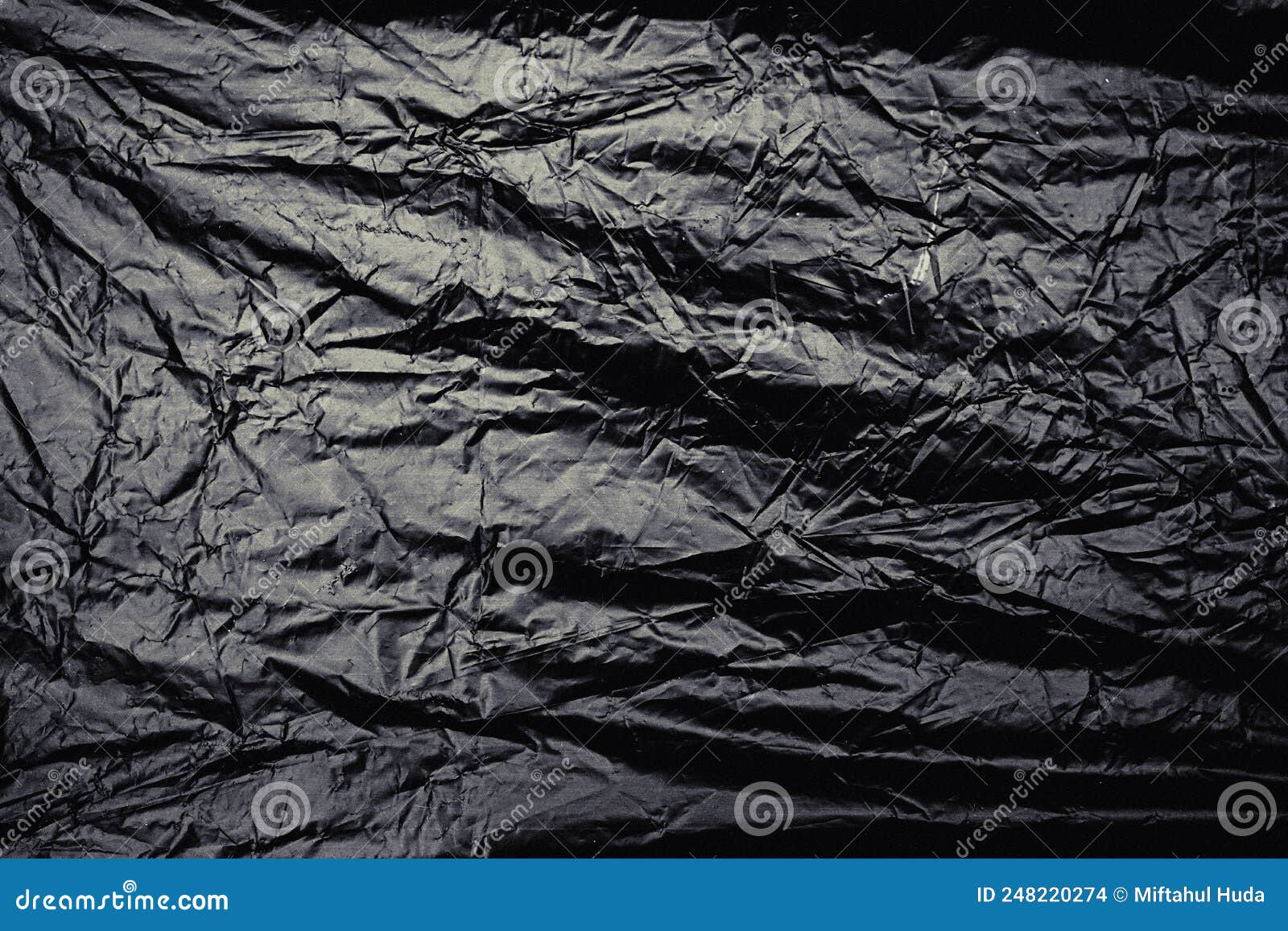 A Transparent Stretch Plastic Wrap Texture on Black Background. Rinkled