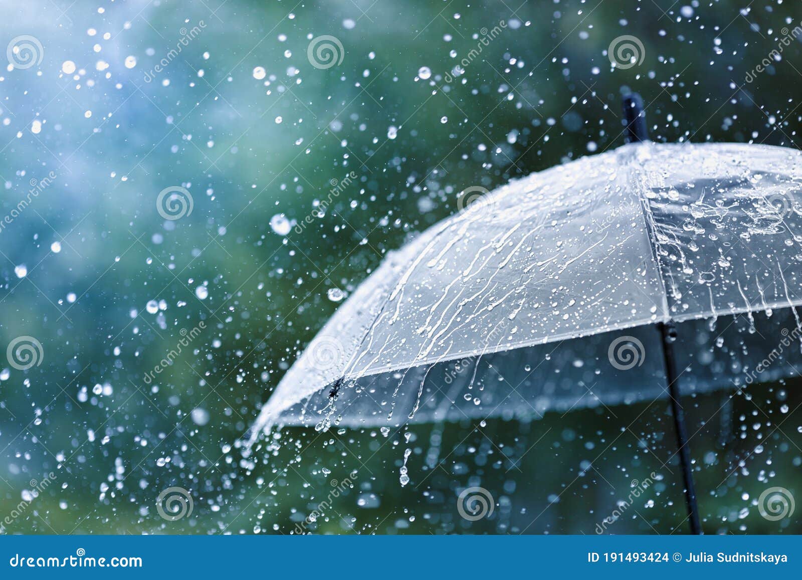 transparent umbrella under rain against water drops splash background. rainy weather concept