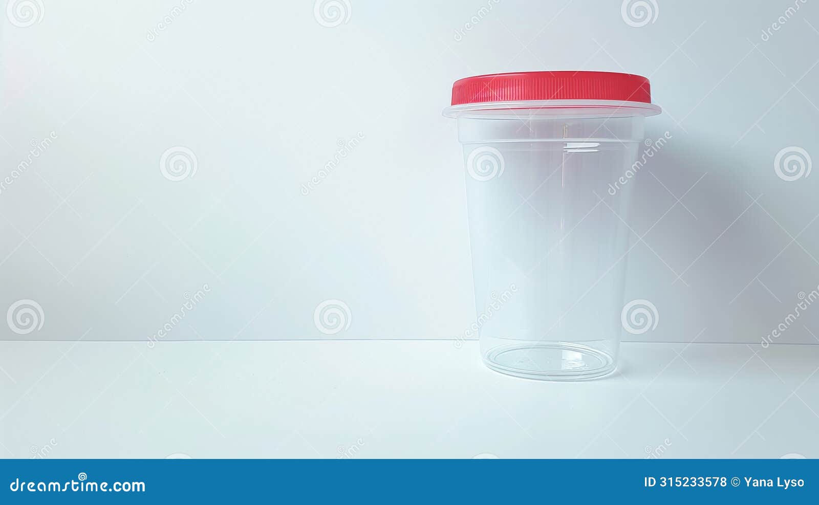 transparent urine analysis container with a red lid. clear specimen cup on a white backdrop. concept of urinalysis