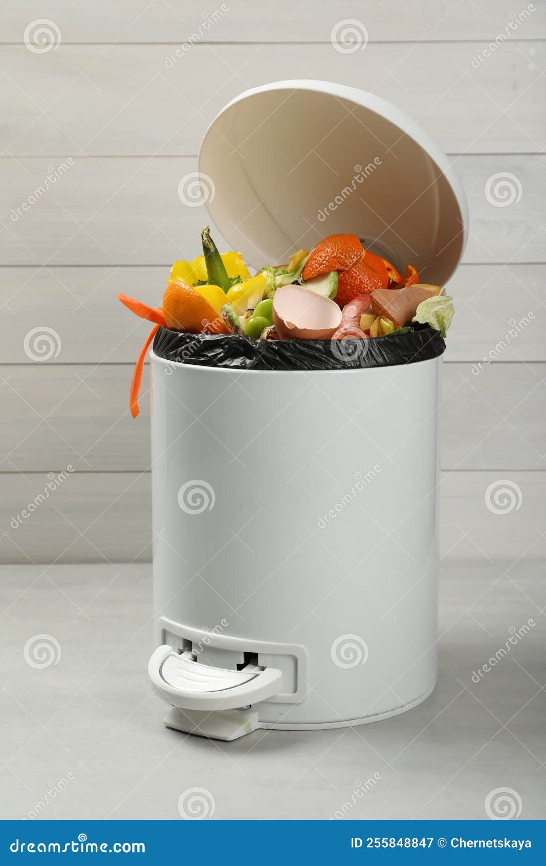 Trash Bin with Organic Waste for Composting on Light Background Stock