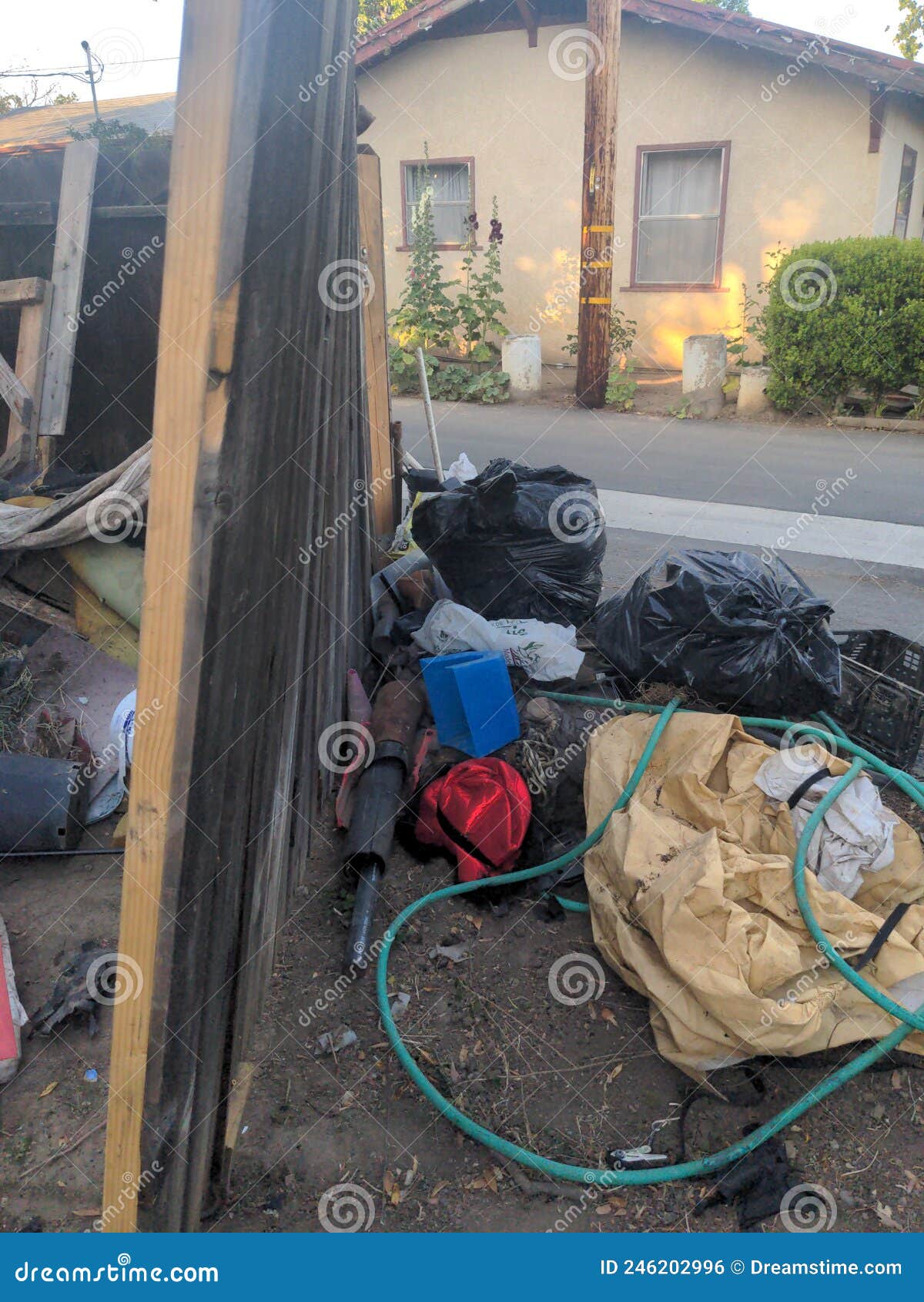 Pile Of Garbage Bags And Messy Trash On Street Sidewalk With Traffic On