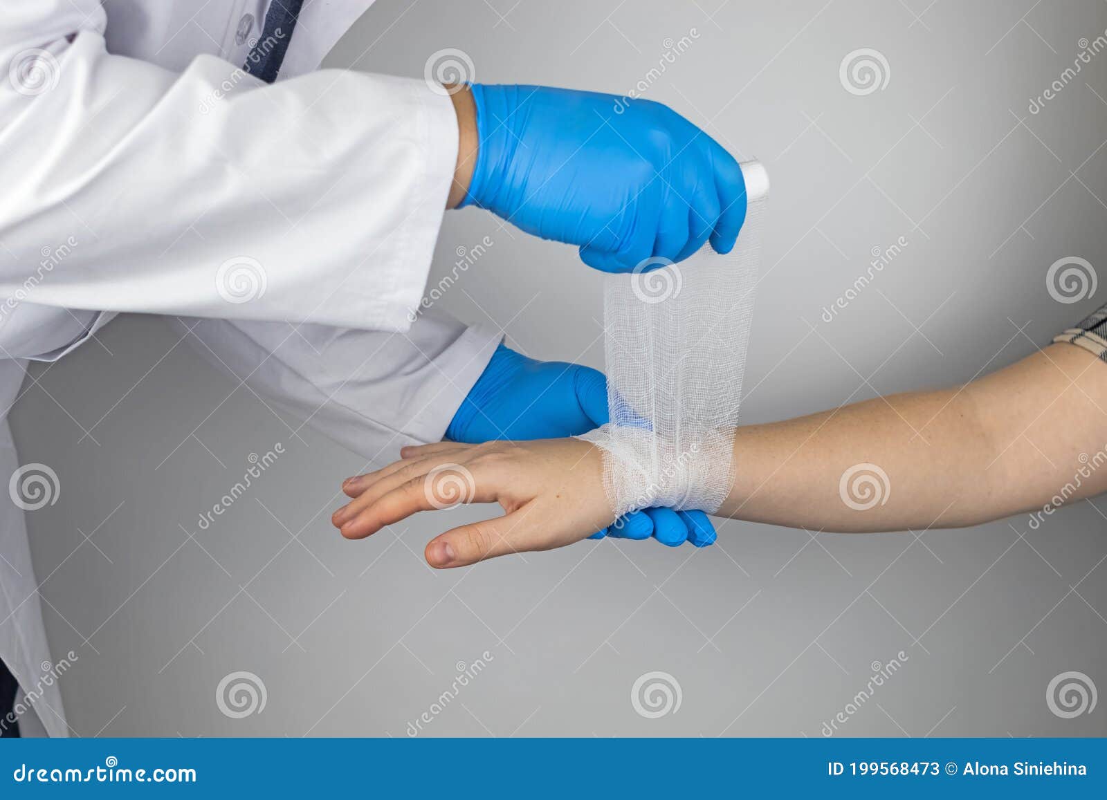 the traumatologist applies a bandage to the patient`s wrist. the concept of helping with fractures and sprains. the technique of