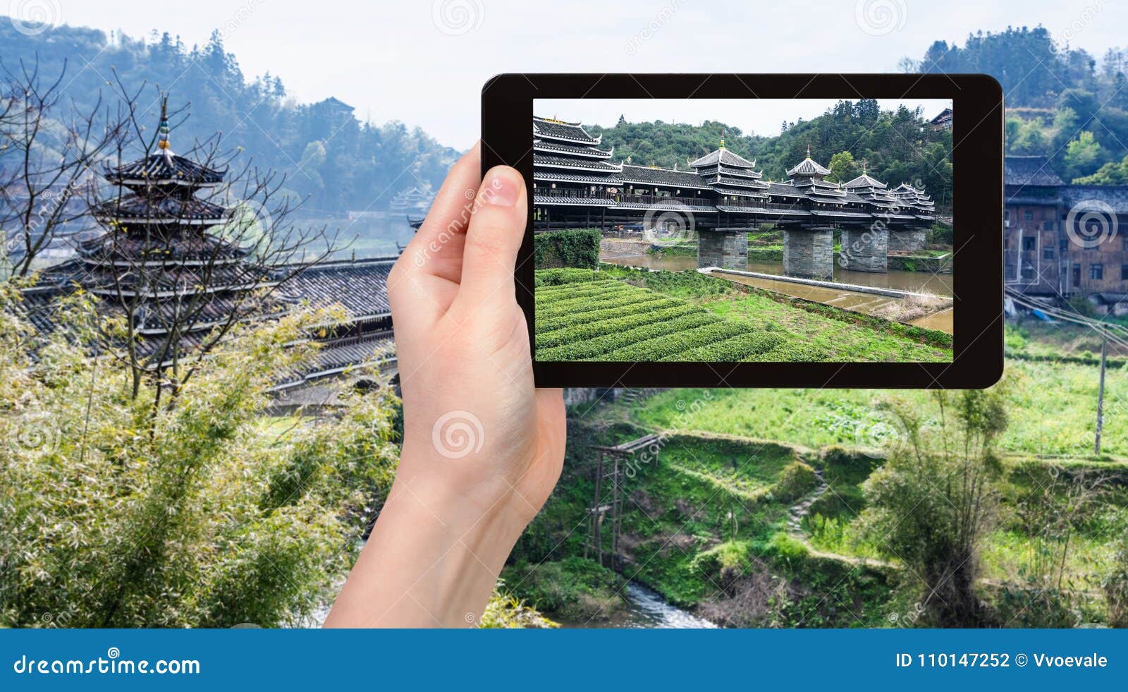 tourist photographs fengyu wind and rain bridge