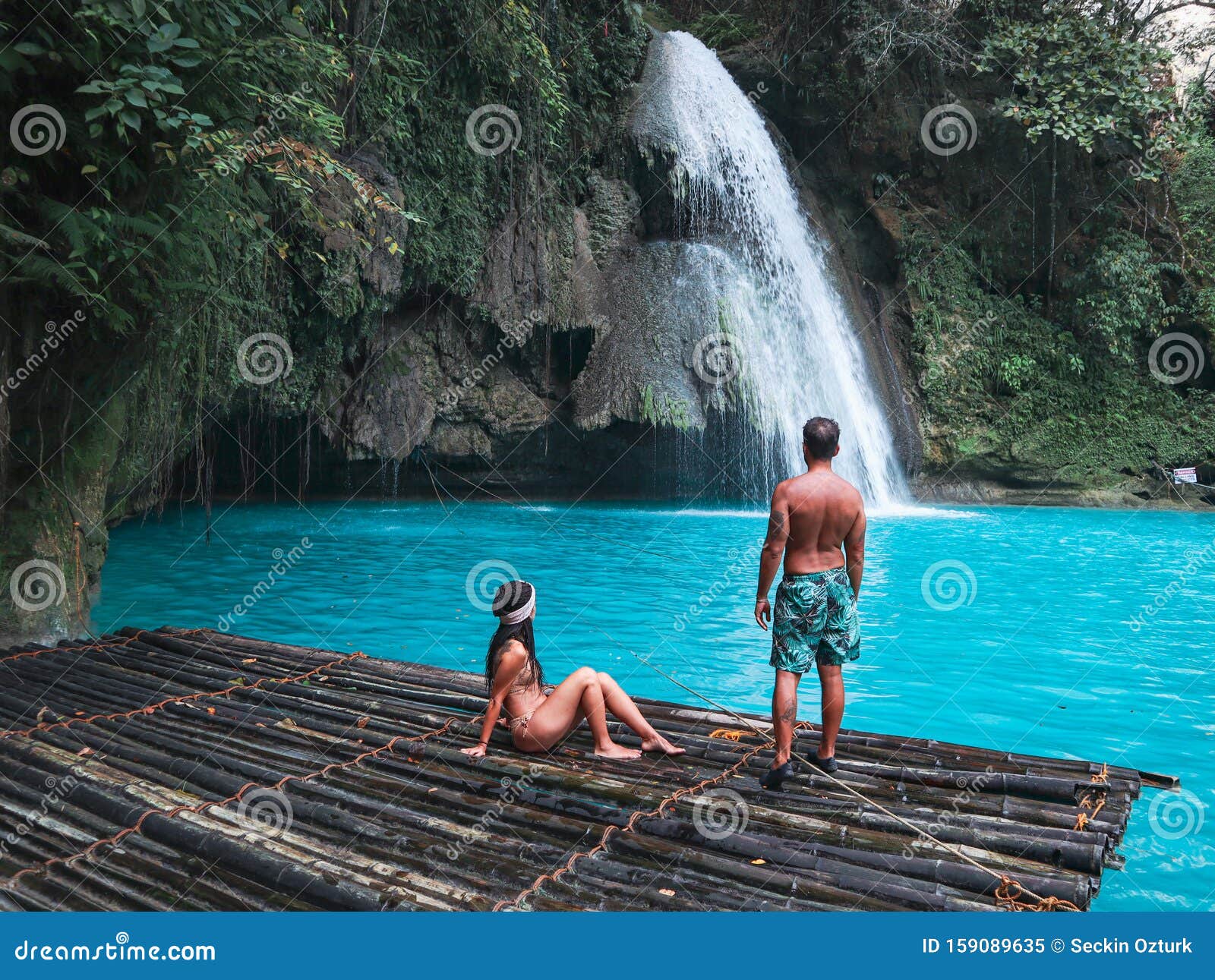 Travel Couple Alone On The Bamboo Raft Of Turquoise Water Of Kawasan Falls In Cebu Stock Image - Image Of Lake, Culture: 159089635